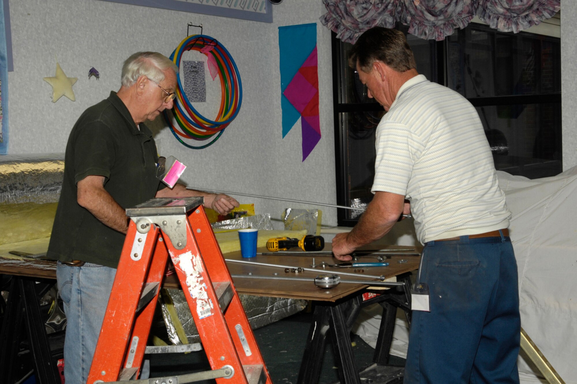 HANSCOM AFB, Mass. -- Contractors Dan Reinold, left, and Bill Reinold work to renovate a Child Development Center Classroom as part of a $1.2 million project to expand center's capacity for children Sept. 25. (U.S. Air Force photo by Linda LaBonte Britt)