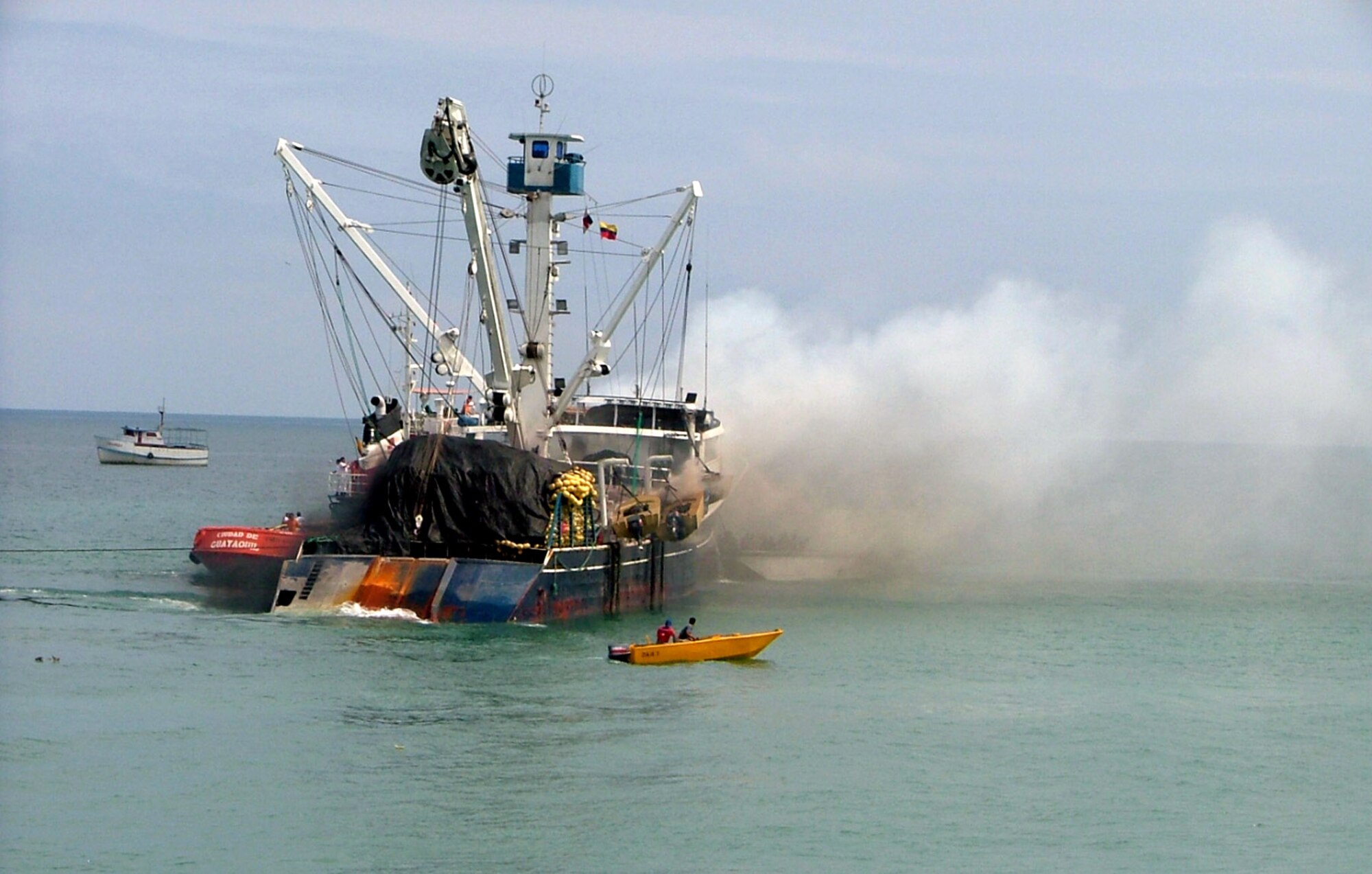 Members from the Forward Operating Location Manta, Ecuador, fire department assisted local authorities in response to a fishing boat fire. (U.S. Air Force Photo/2nd Lt. Naomi Evangelista)
