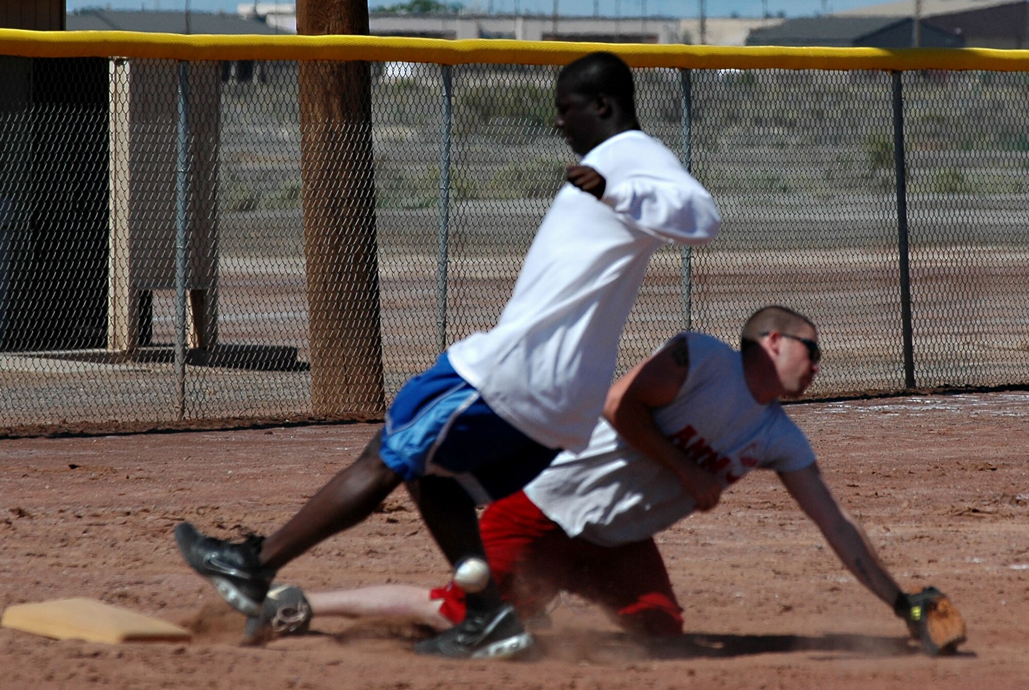 The 49th Logistics Readiness Squadron slid passed the Ammunitions flight 12-11 during the Sports Day one-pitch softball tournament Sept. 26. (U.S. Air Force photo/Airman 1st Class Heather Stanton)