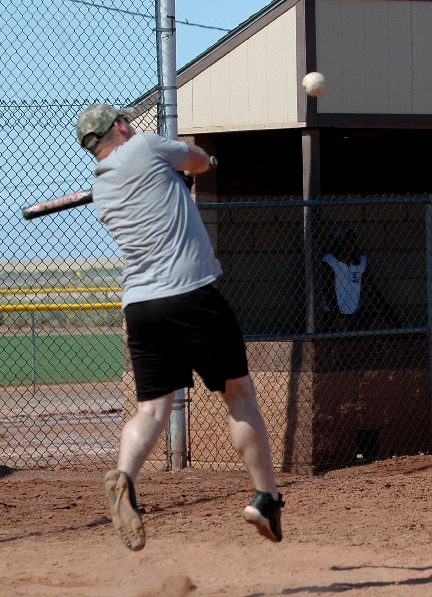 Senior Airman John Hammons, 49th Civil Engineer Readiness Squadron, reaches for the pitch during the 49 CES and 49th Maintenance Squadron softball game Sept. 26 for Sports Day. Hammons had to jump for the pitch because each batter was given one pitch, good or bad. (U.S. Air Force photo/Airman 1st Class Heather Stanton)