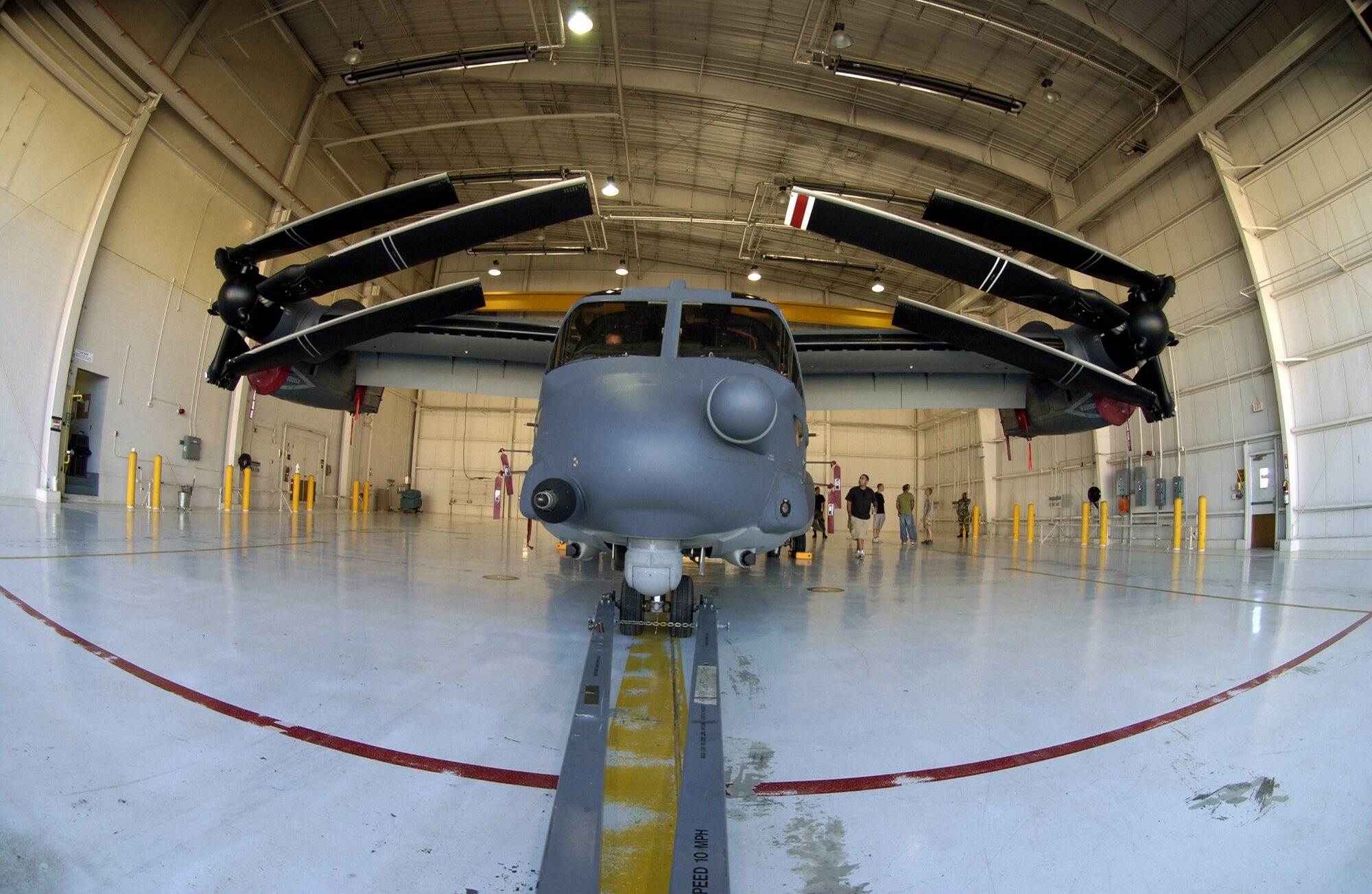 A CV-22 Osprey with its rotors folded sits in a hangar during a hangar clearance test Sept. 25 at Cannon AFB, N.M. Cannon AFB will be transferred from Air Combat Command to Air Force Special Operations Command Oct. 1. CV-22s are among the special operations aircraft to be assigned to the 27th Special Operations Wing at Cannon. (U.S. Air Force photo/Greg Allen)
