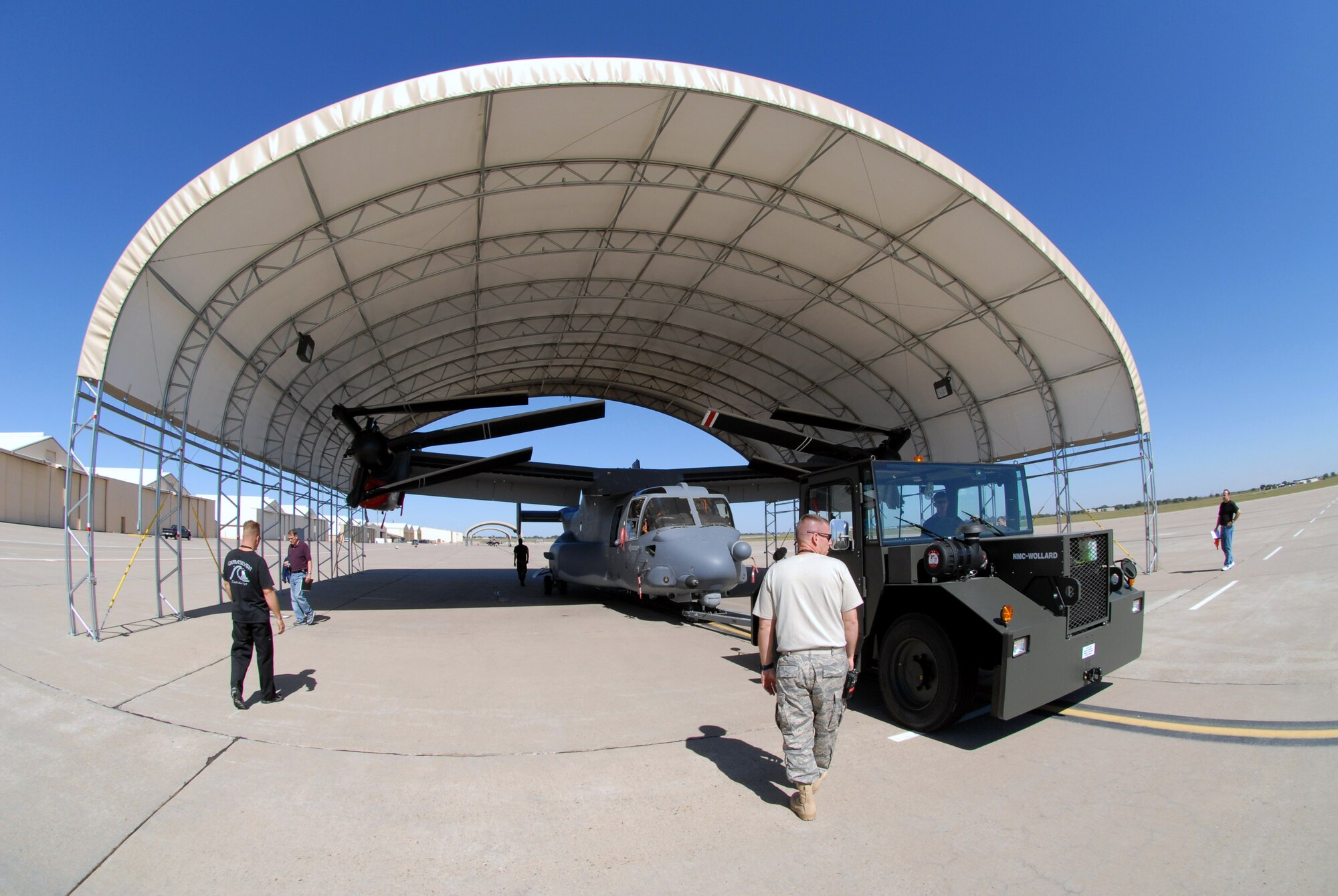Airmen check the fit of a CV-22 Osprey in a flightline sun shelter Sept. 25 at Cannon Air Force Base, N.M. Cannon AFB will be transferred from Air Combat Command to Air Force Special Operations Command Oct. 1. CV-22s are among the special operations aircraft to be assigned to the 27th Special Operations Wing at Cannon AFB. The wing, formerly designated the 27th Fighter Wing, operated F-16 Fighting Falcons at the base from 1995 to 2007. (U.S. Air Force/Chief Master Sgt. Gary Emery) 
