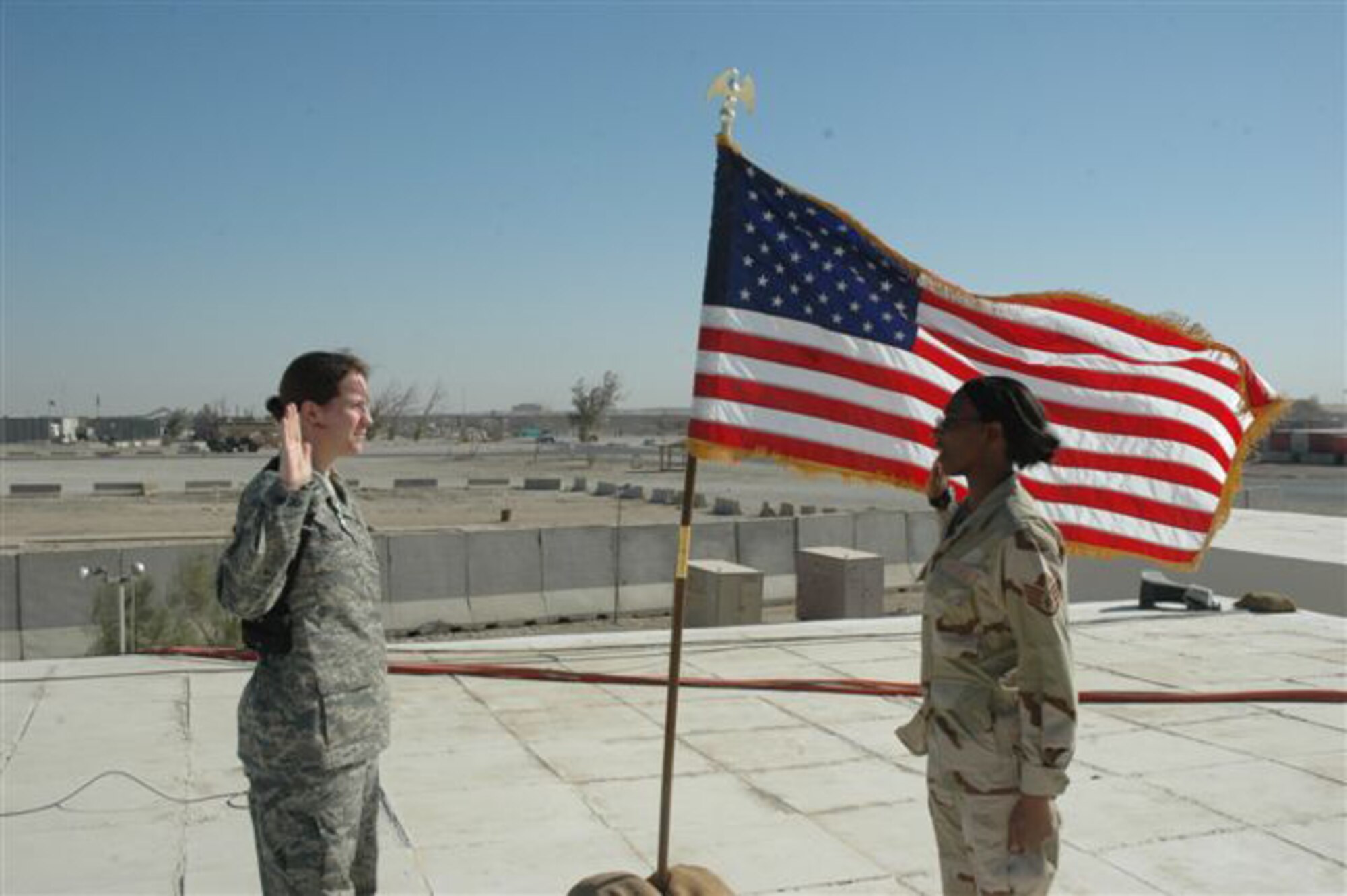 ALI AIR BASE, Iraq -- Left to right: Capt. Jodi Kelsey, 374th Logistics Readiness Squadron, recites the Oath of Enlistment to Staff Sgt. Kim Howard, 509th Security Forces Squadron, Sept. 27 at Ali Air Base, Iraq. (Photo printed with permission of Staff Sgt. Kim Howard) 