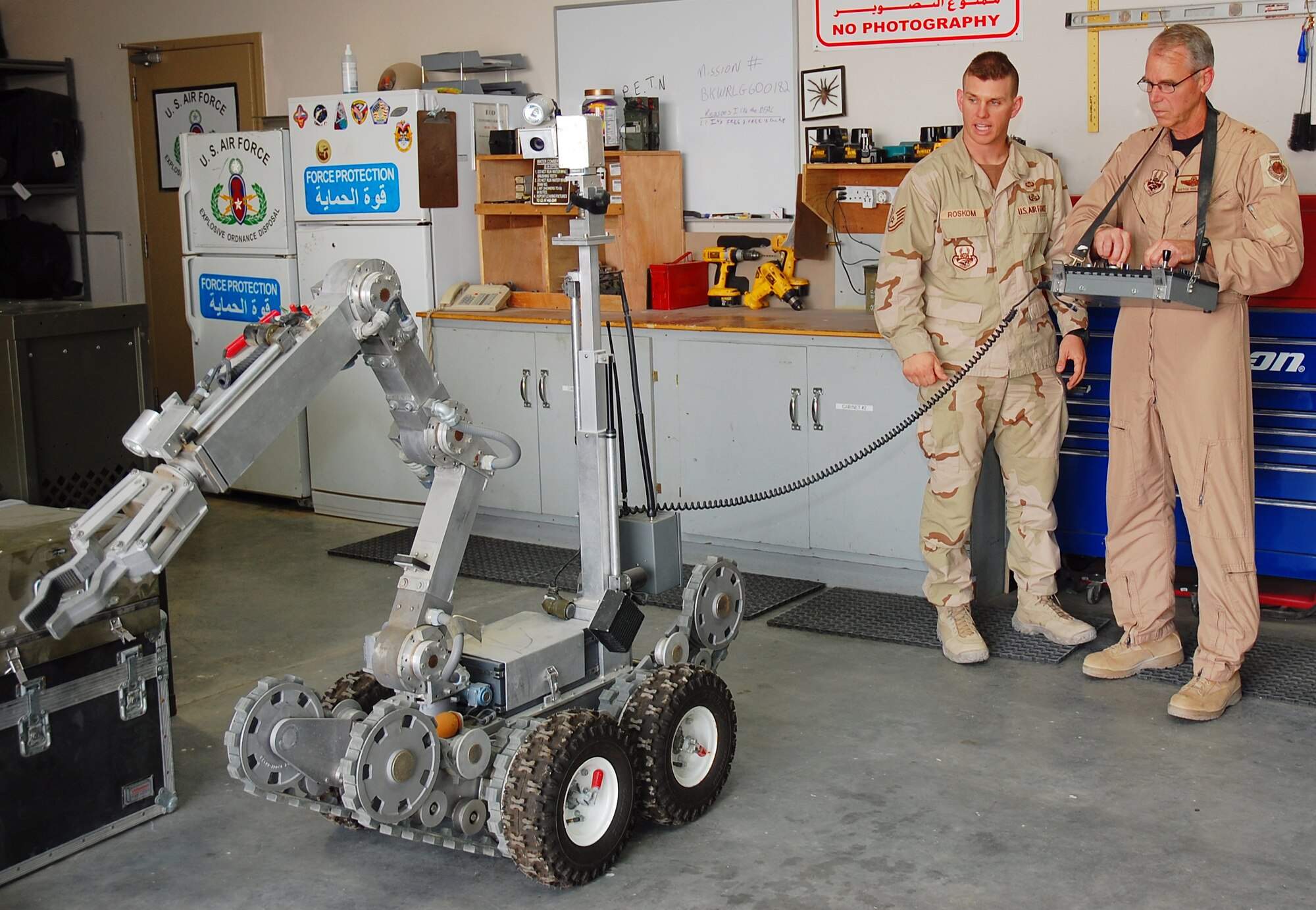 SOUTHWEST ASIA -- Tech. Sgt. John Roskom, 386th Expeditionary Civil Engineering Squadron explosive rrdnance disposal specialist, assists Maj. Gen. William "Dutch" Holland, Vice Commander, 9th Air Force and Deputy Commander, U.S. Central Command Air Forces, in the maneuvering of an F6A EOD robot to recover a training aid during General Holland's visit to an undisclosed location in Southwest Asia Sept 30.  Sergeant Roskom is deployed from Pope AFB, N.C.  (U.S. Air Force photo by Staff Sgt. Tia Schroeder)