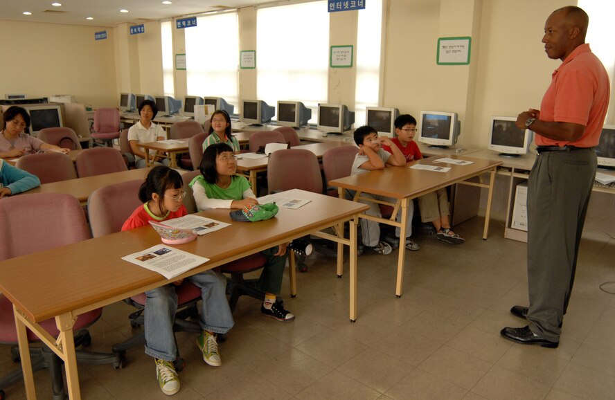 KUNSAN AIR BASE, South Korea - Colonel CQ Brown, 8th Fighter Wing Commander, discusses the story of Spider-Man with a group of Korean kids at the Gunsan City library during a storytelling session Sept. 29.  Col. Brown read several books during the reading session.  The reading program, a new initiative meant to help Korean kids learn English is part of the Good Neighbor Program, a program used to foster relations with the local community and Airmen assigned here.  (U.S. Air Force photo/ TSgt. Quinton T. Burris)