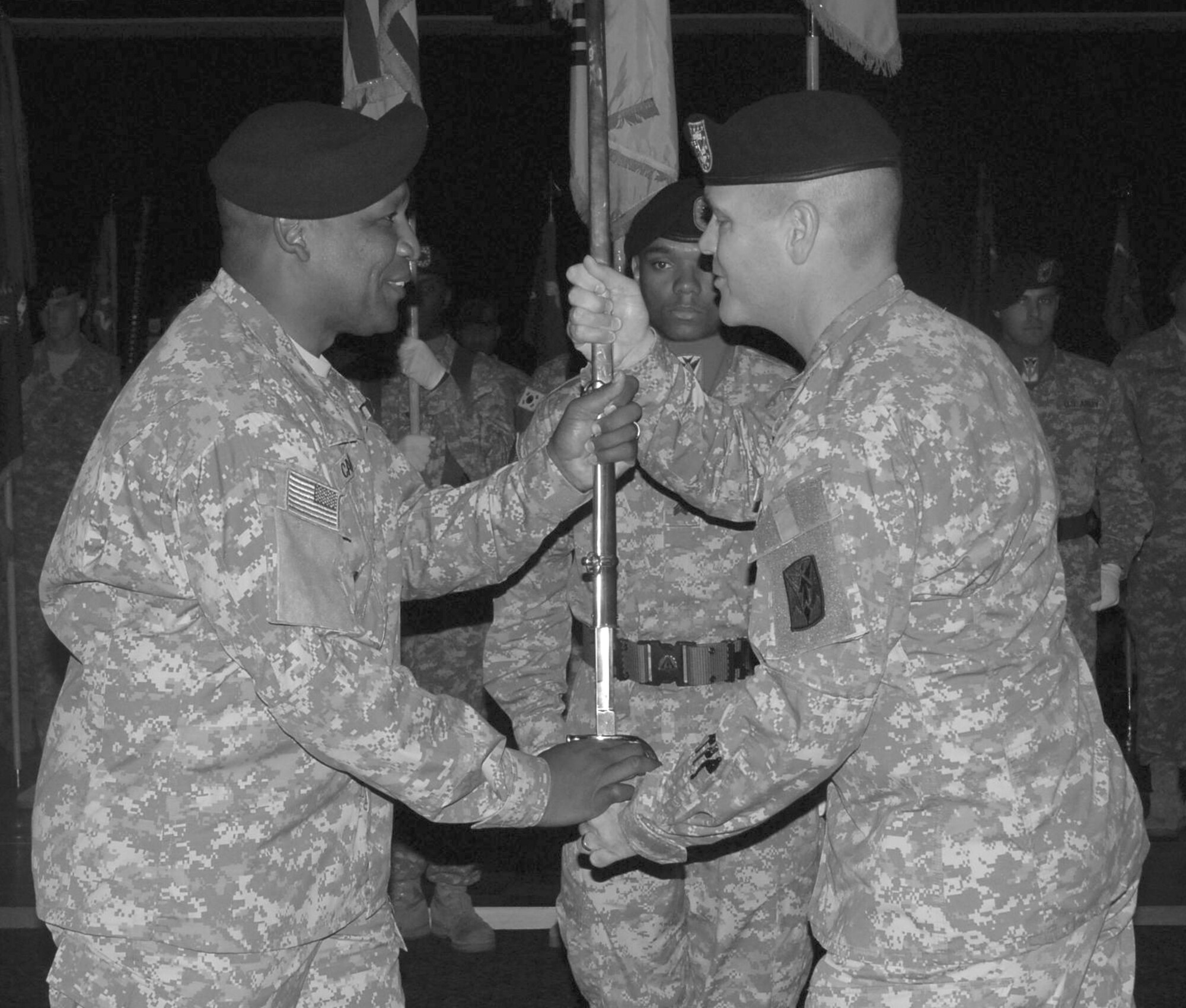 OSAN AIR BASE, Republic of Korea --  Command Sgt. Maj. James T. Carr (left) accepts the Non-Commissioned Officer sword from Col. James H. Dickinson, 35th ADA BDE commander, symbolizing Carr’s new responsibility as the brigade command sergeant major during an Assumption of Responsibility Ceremony held at the Challenger Enlisted Club here Oct. 1. (U.S. Army photo by Pfc. Gretchen N. Goodrich)
