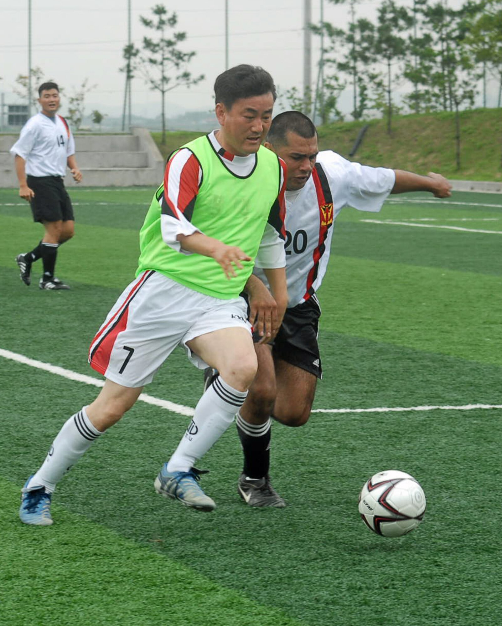 PYEONGTAEK CITY, Republic of Korea --  Spc. Michael A. Macias, a food service specialist with HHB 35th ADA BDE, fights for the ball against a member of the Pyeongtaek City Hall during the Korea-US Military Forces and Government Friendship Soccer Tournament at the Pyeongtaek Public Stadium on Sept. 21. (U.S. Army photo by Pfc. Gretchen N. Goodrich)