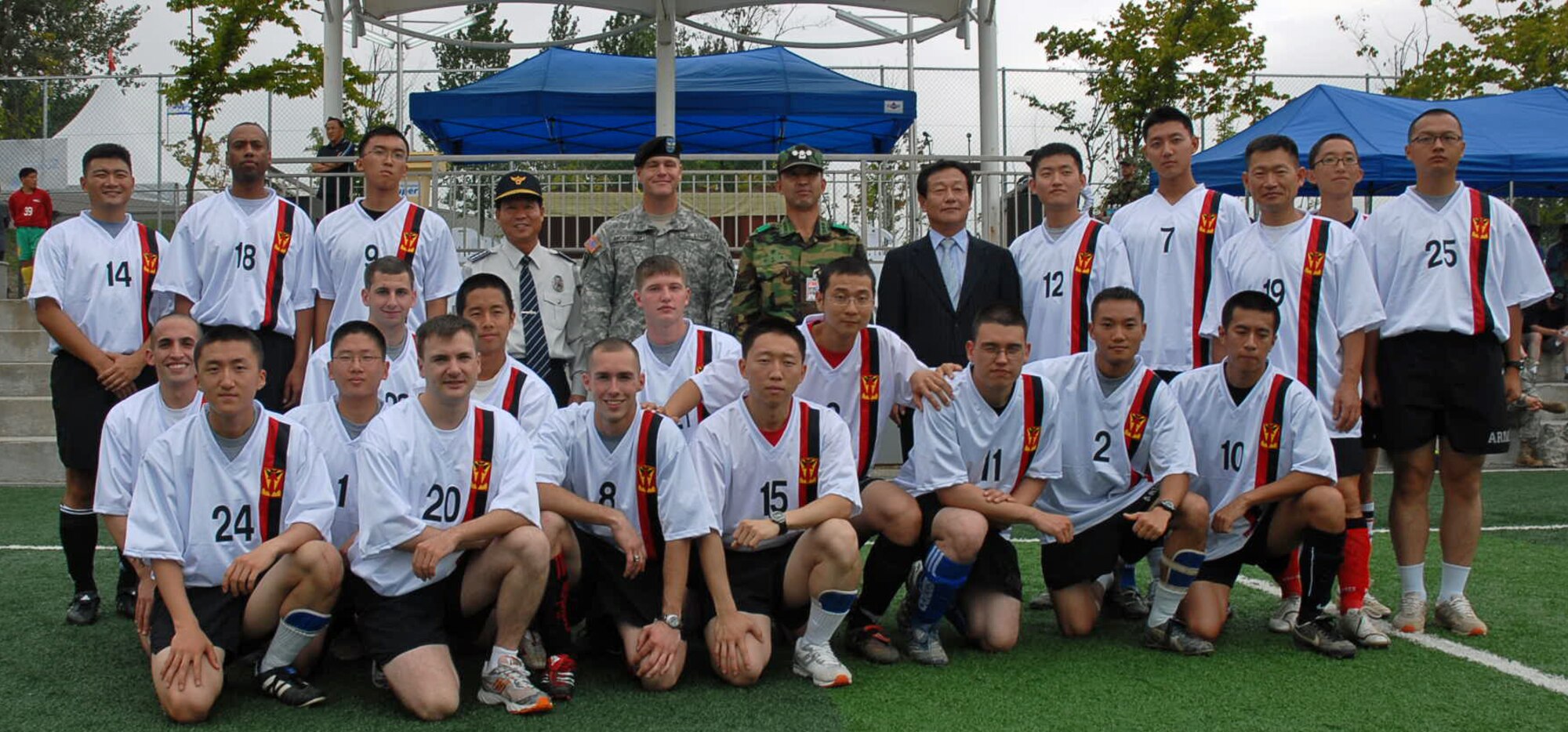 PYEONGTAEK CITY, Republic of Korea --  The entire HHB 35th ADA BDE team poses for a team photo before the start of the first Korea-U.S. Military Forces and Government Friendship Soccer Tournament at the Pyeongtaek Public Stadium on Sept. 21., along with Col. James H. Dickinson, 35th ADA BDE commander (center). (U.S. Army photo by Pfc. Gretchen N. Goodrich)