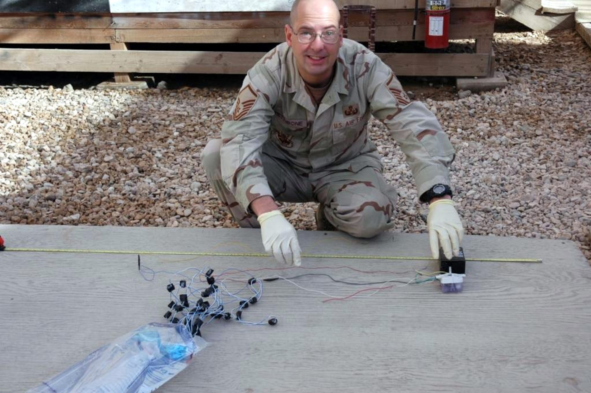 SPANGDAHELM AIR BASE, Germany – During his deployment to Iraq, Master Sgt. Ken Pettibone, 52nd Civil Engineer Squadron NCOIC of Explosive Ordnance Disposal Operations, processes a pressure wire from a Victim Operated improvised explosive device. Sergeant Pettibone was deployed for one year to Iraq where he served at Forward Operation Base Kalsu, Camp Slayer and Camp Taji, Iraq. (Courtesy photo)
