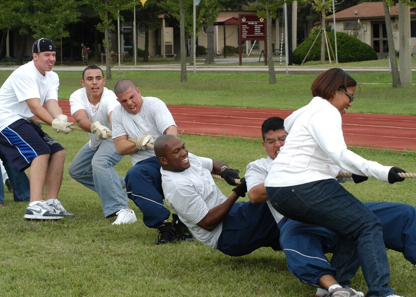 KUNSAN AIR BASE, South Korea – Airmen of the 8th Logistic Readiness Squadron pull with all there strength during the tug-of-war contest against 8th Fighter Wing staff Sept. 28 here. The 8th Logistic Readiness Squadron Airmen along with others participated in a number of events during the 8th Fighter Wing Sports Day. The sports day allows Airmen a way to compete in friendly and fun competitions, helping to build esprit de corps. The day kicked off with a wing run and events, ranging from a Texas Hold ‘Em tournament to unit paintball challenges. (U.S. Air Force photo/Staff Sergeant Araceli Alarcon)                                