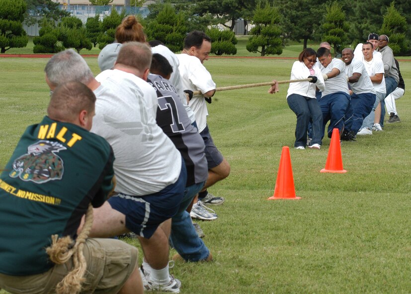 KUNSAN AIR BASE, South Korea – Airmen of the 8th Fighter Wing Staff pull with all their strength during the tug-of-war contest against the 8th Logistics Readiness Squadron Sept. 28 here. The 8th Fighter Wing staff along with others participated in a number of events during the 8th Fighter Wing Sports Day. The sports day allows Airmen a way to compete in friendly and fun competitions, helping to build esprit de corps. The day kicked off with a wing run and events, ranging from a Texas Hold ‘Em tournament to unit paintball challenges. (U.S. Air Force photo/Staff Sergeant Araceli Alarcon)                                