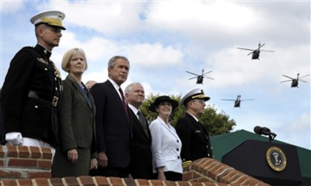 Left to Right, Retired Chairman of the Joint Chiefs of Staff Gen. Peter Pace, his wife Lynne Pace, President George W. Bush, Secretary of Defense Robert M. Gates, Deborah Mullen, and Chairman of the Joint Chiefs of Staff Navy Adm. Michael G. Mullen watch a military fly-over during an Armed Forces Hail and Farewell ceremony on Fort Myer, Va., Oct. 1, 2007.
