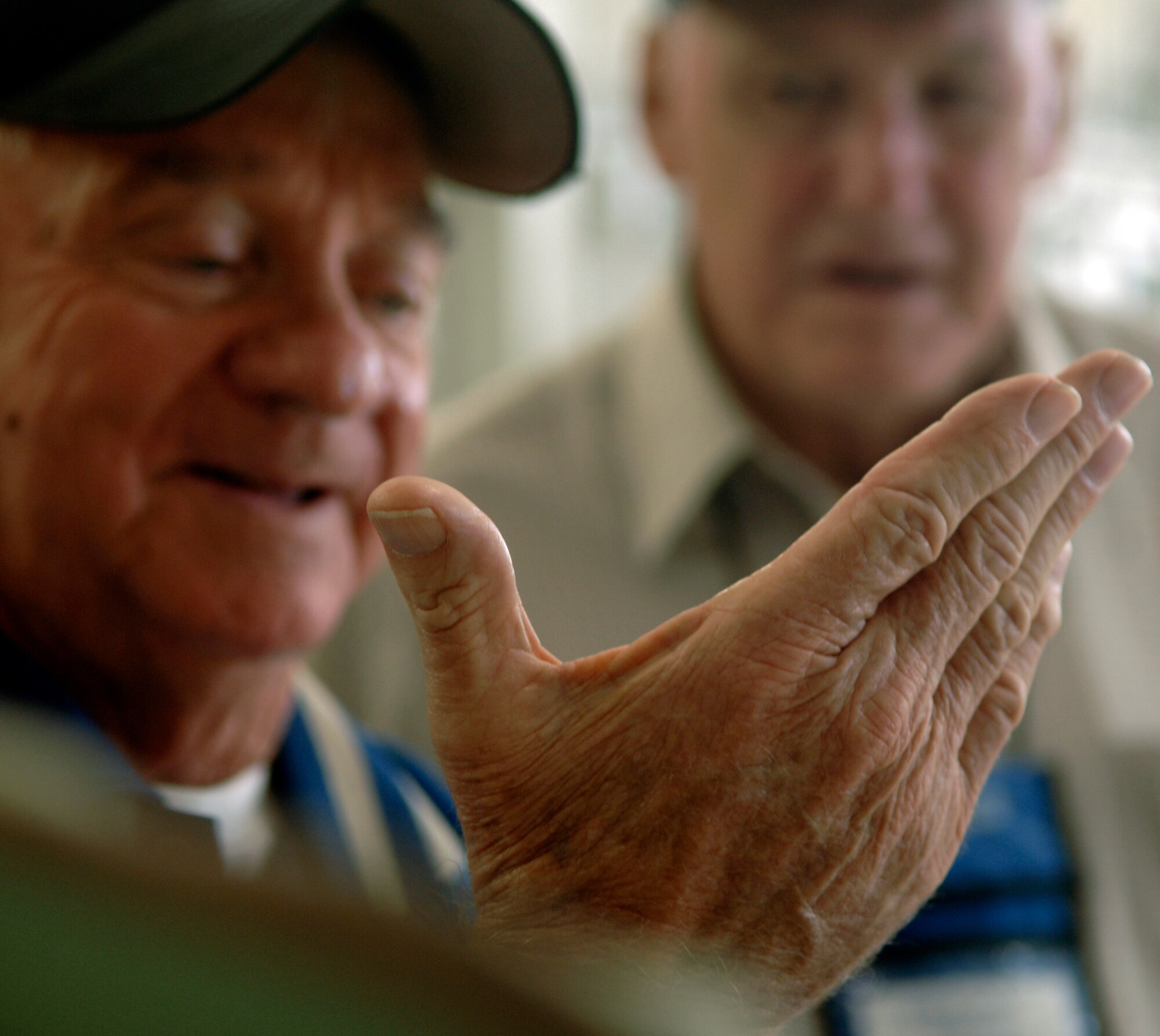 LANGLEY AIR FORCE BASE, Va. -- Bill Morrissey of the Berlin Airlift Veterans Association speaks about his hand injury while flying missions with fellow veterans Richard Pilon and Gail Halvorsen. Morrissey, Pilon and Halvorsen are among the Berlin Airlift Veterans that visited Langley Oct. 1.  (U.S. Air Force photo/Airman 1st Class Vernon Young)