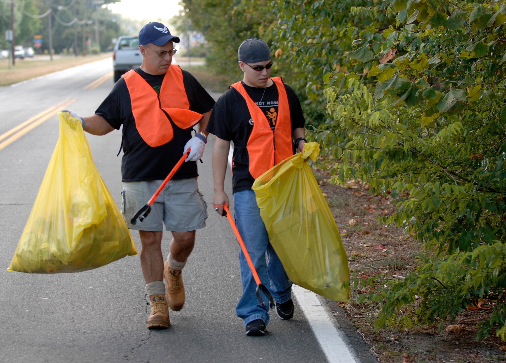 LANGLEY AIR FORCE BASE, Va. -- Retired Master Sgt. Mike Byrd, Air Combat Command Flight Operations and Training Branch analyst and Airman 1st Class Christopher Lancaster, 10th Intelligence Squadron network technician, pick up trash outside the King Street Gate Sept. 28. The cleanup was conducted by volunteers from the Air Force Sergeants Association as part of the Adopt-A-Spot program in Hampton. (U.S. Air Force photo/Tech. Sgt. Levi Collins)