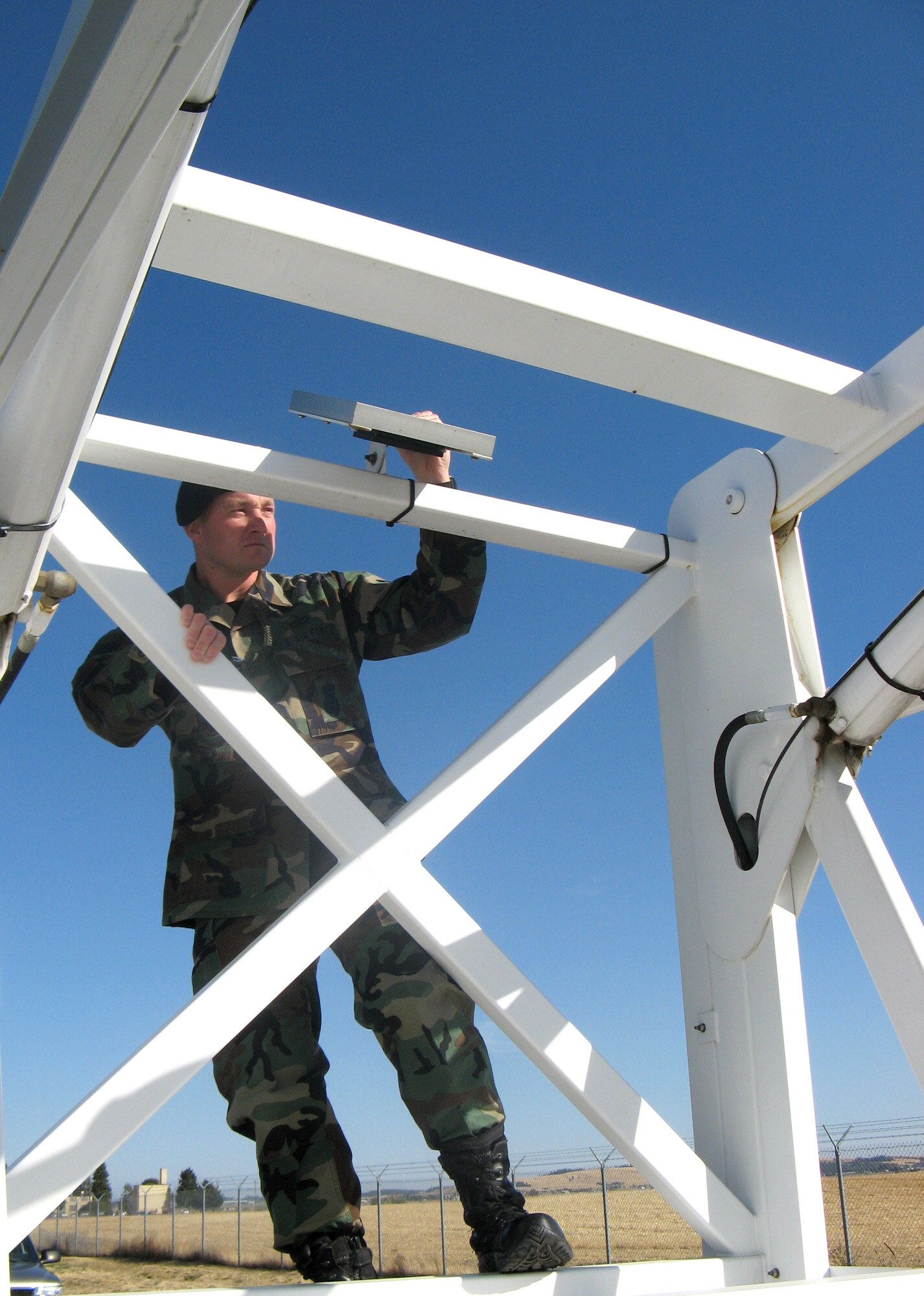 FAIRCHILD AIR FORCE BASE, Wash. – Tech. Segt. Dan Merrill, Fairchild NCO-in-charge of the Installation Security Constable program, checks the bars on the “Sky Watch” tower, a mobile surveillance tower, prior to positioning it. (U.S. Air Force photo/Shadi May)