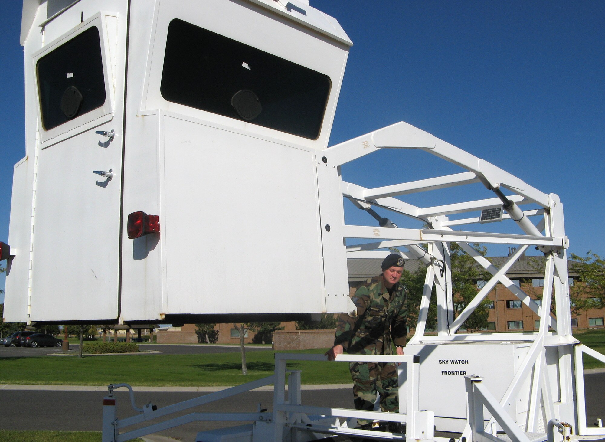 FAIRCHILD AIR FORCE BASE, Wash. – Tech. Sgt. Dan Merrill, Fairchild NCO-in-charge of the Installation Security Constable program, adjusts the solar panel on the “Sky Watch” tower, a mobile surveillance tower. (U.S. Air Force photo/Shadi May)
