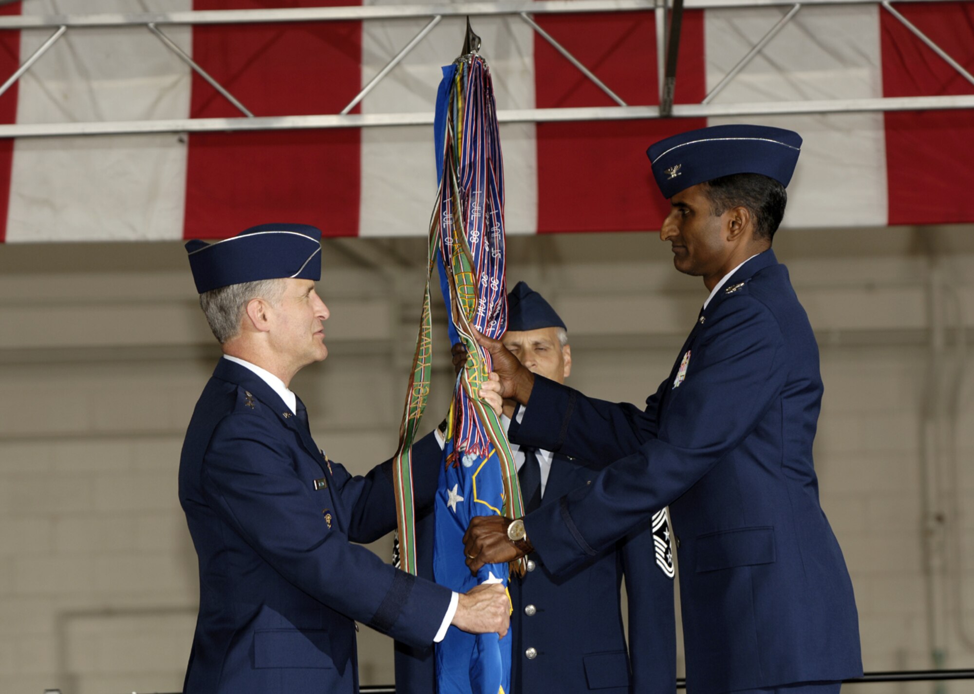 Maj. Gen. James Hawkins, 18th Air Force commander, passes the wing flag to Col. Balan Ayyar, the new 305th Air Mobility Wing commander, at a change-of-command ceremony here Oct. 2. Colonel Ayyar comes to McGuire from Grand Forks Air Force Base, N.D., where he was the vice commander of the 319th Air Refueling Wing. (U.S. Air Force photo/Kenn Mann)
