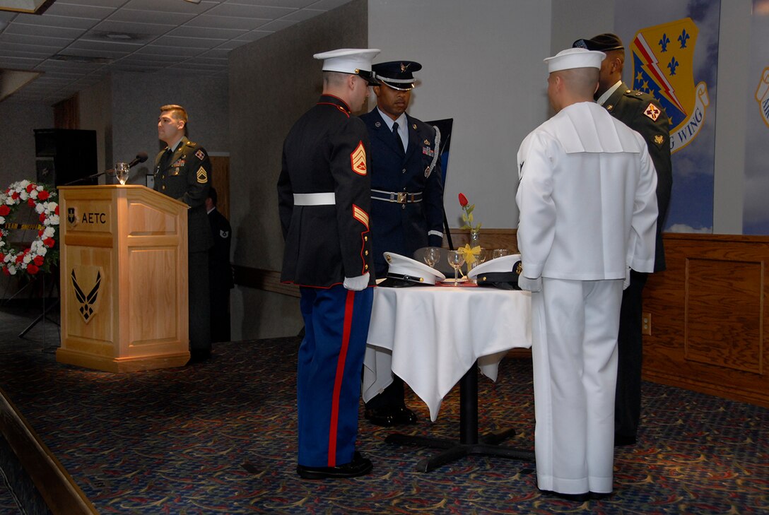 Members of the United States Army, Navy, Air Force and Marines honor their captured and missing fellow servicemembers during the POW/MIA luncheon at the Sheppard Club Sept. 28.  (U.S. Air Force photo/Sandy Wassenmiller)