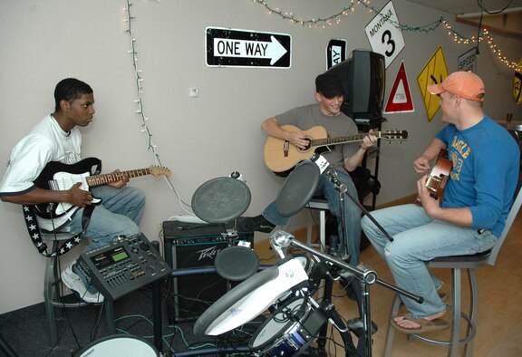 Airman 1st Class Marques Littles, 341st Logistics Readiness Squadron; Airman 1st Class Dan Burch, 341st Missile Security Forces Squadron; and Senior Airman Jacob See, 341st Security Forces Group, jam at the Detour Sept. 27. The Detour just turned 1 year old. (U.S. Air Force photo by Airman 1st Class Dillon White) 
