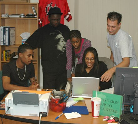 Airmen volunteers plan a poetry event at the Detour Airmen's Center at Malmstrom Air Force Base. The Airmen's Center provides free coffee, sodas, Internet, video games and a place to hang out on base. (U.S. Air Force photo/ Airman 1st Class Dillon White) 
