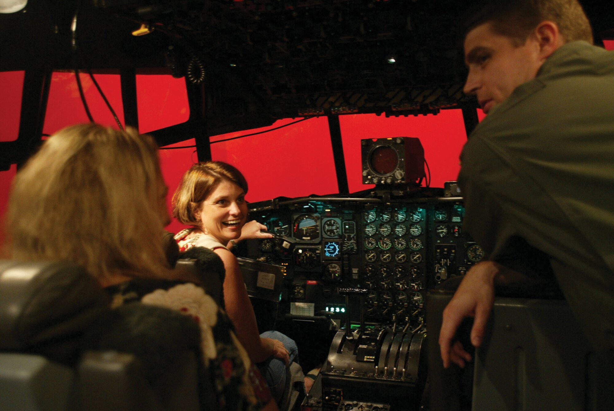 Lisa Allen, wife of Lt. Col. Rob Allen of the 700th Airlift Squadron, has a laugh  after a "rough landing" that resulted in the "red screen of death" at the Eastern Regional Flight Simulator here. Spouses were treated to a full day of reserve life as part of the annual event meant to help reward spouses of Airmen in retention critical areas. 
