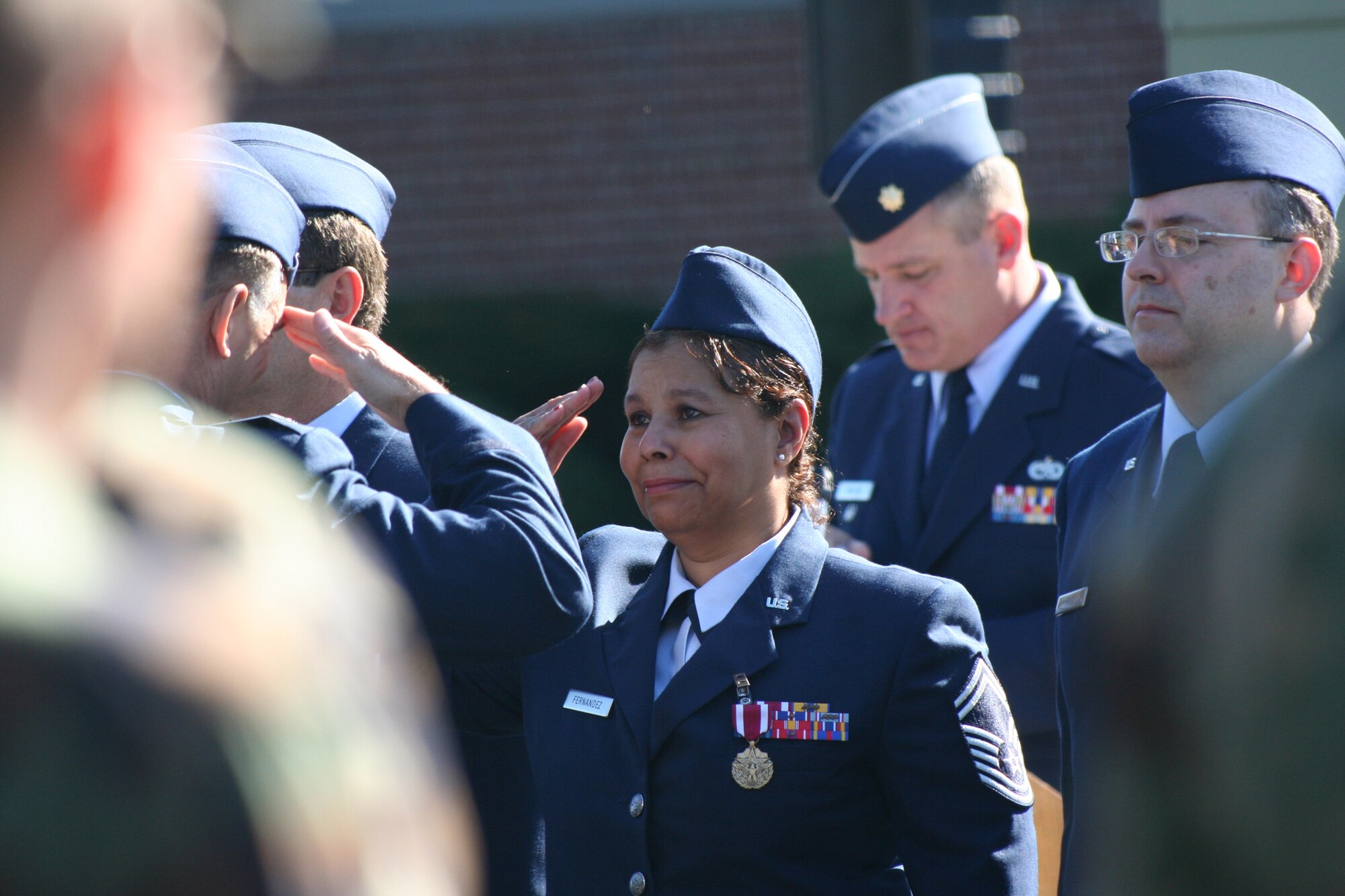 Senior Master Sgt. Julie M. Fernandez salutes Col. Girodano "Jody" McMullen, 913th Airlift Wing commander, one last time, during a mass retirement ceremony Sept. 30, 2007 at Willow Grove Air Reserve Station, Penn. Sergeant Fernandez was among 15 reservists who retired just prior to the wing's inactivation ceremony. The 913th was inactivated as a result of an Air Force Reserve Command 2007 Programmatic Budget Directive action. The ceremony was a somber moment for the 150 remaining members of the wing on hand for the retirement, inactivation and retreat ceremonies. When the flag was lowered for the last time, members hugged and with teary eyed smiles, said their goodbyes. (U.S. Air Force photo by Phil Rhodes)