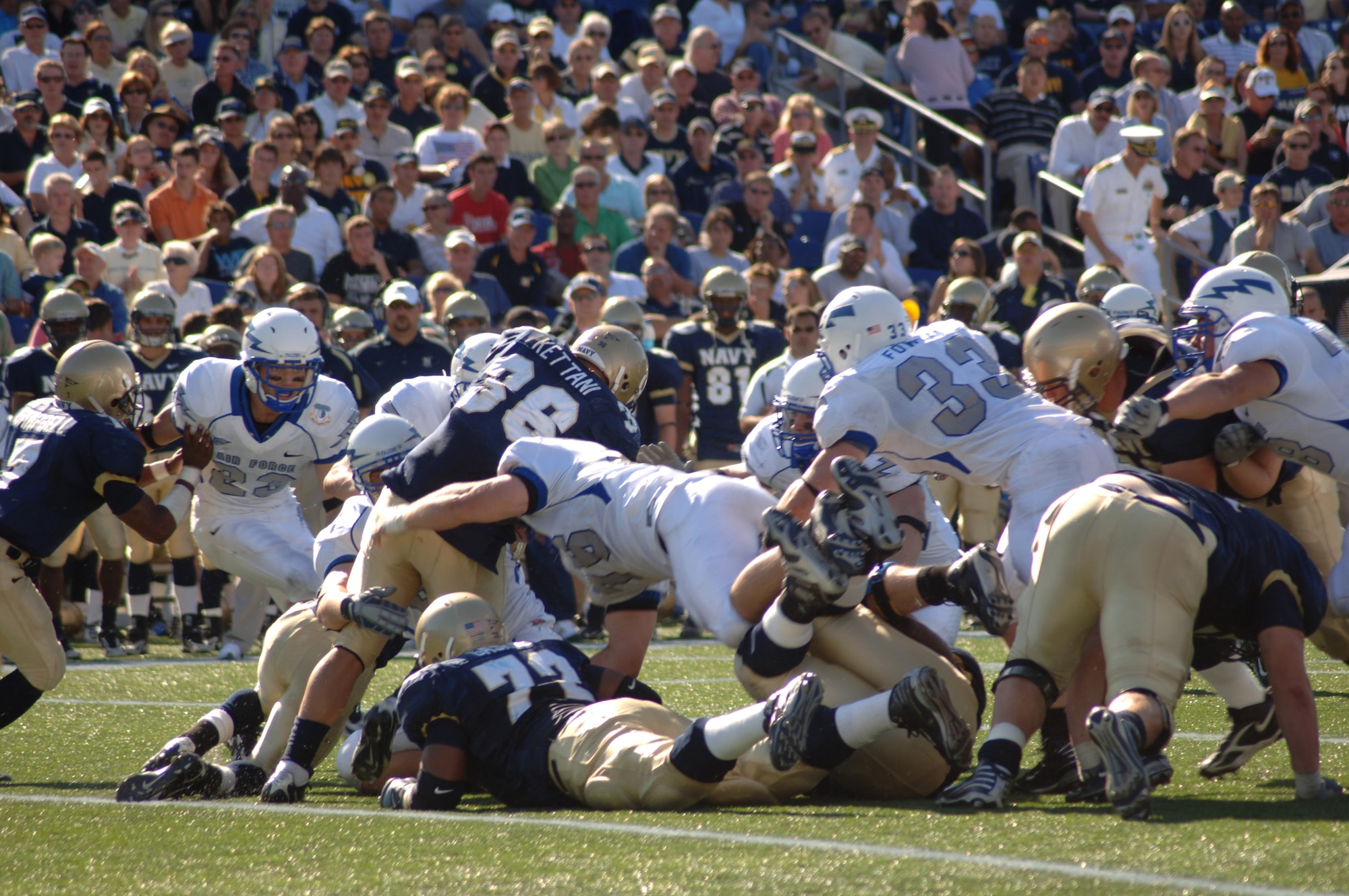 U.S. Air Force Academy Falcon noise guard Stephen Larson, 76, leads the defensive charge into Navy fullback Eric Kettani, 36, during Air Force's 31-20 loss to the Midshipmen Sept. 29 at Annapolis, Md. Larson had a career high seven tackles and a sack in the game. (U.S. Air Force photo/Capt. Jillian Torango) 

