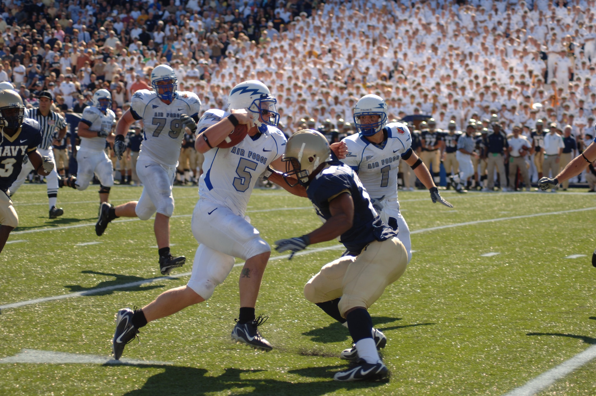U.S. Air Force Academy Falcon quarterback Shaun Carney tries to sidestep a Navy defender during Air Force's 31-20 loss to Navy Sept. 29 at Annapolis, Md. The senior signal caller gained 300 total yards to become the program's all-time leader in total yards from scrimmage with 6,780. (U.S. Air Force photo/Capt. Jillian Torango) 
