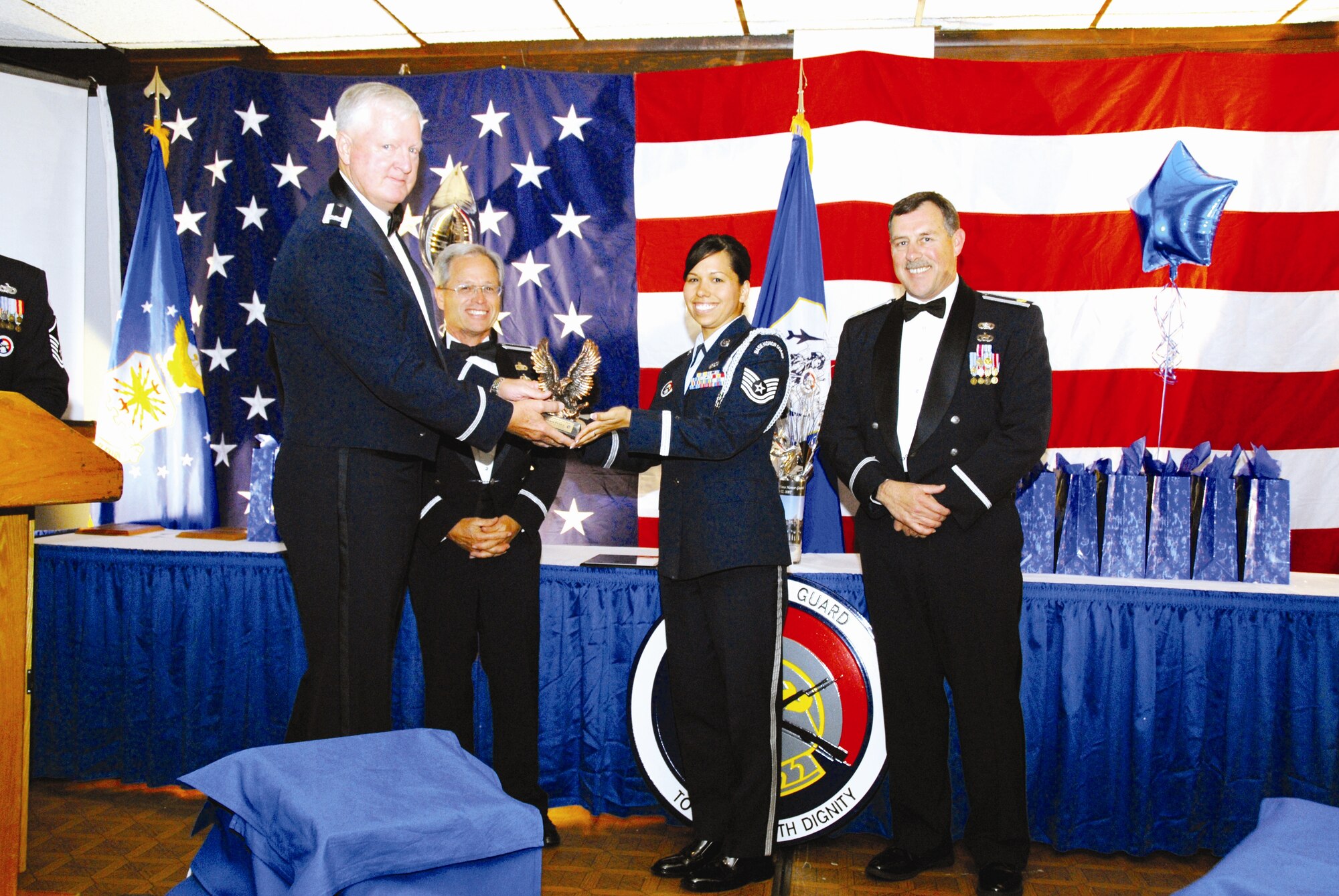 Tech Sgt. Dawn Perez, 95th Air Base Wing, is recognized as honor guard member of the year by Col. Michael Woolley (left), 95th Mission Support Group Commander, along with representatives from the 452nd AMW and the 163rd RW. (U.S. Air Force photos by Senior Airman Diane Ducat)