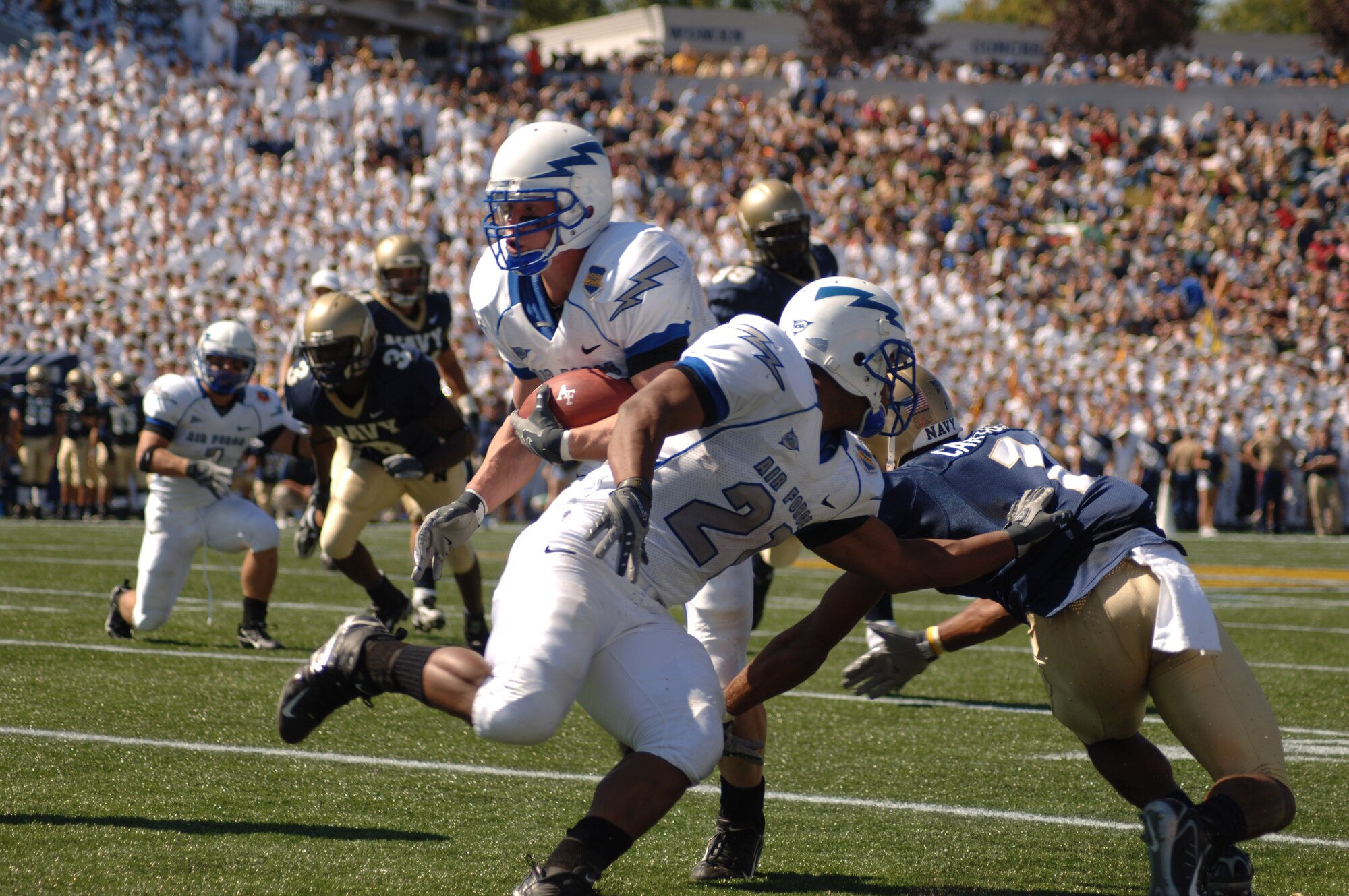 U.S. Air Force Academy Falcon tailback Kip McCarthy eyes extra yardage while fullback Ryan Williams attempts to block Navy safety Blake Carter during Air Force's 31-20 loss to the Midshipmen Sept. 29 at Annapolis, Md. The Falcons gained 237 yards on the ground. (U.S. Air Force photo/Capt. Jillian Torango) 


