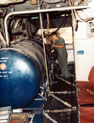 A1C Richard Wolfe checks the herbicide level as it is pumped into the storage tank aboard a UC-123K in 1969. (U.S. Air Force photo)