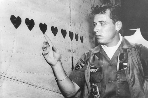 Many Ranch Hand personnel received Purple Hearts for wounds in action. They also recorded them as hearts on the side of their aircraft. Here, A1C Michael L. Shuppert points to his on the C-123 named Leper Colony. (U.S. Air Force photo)