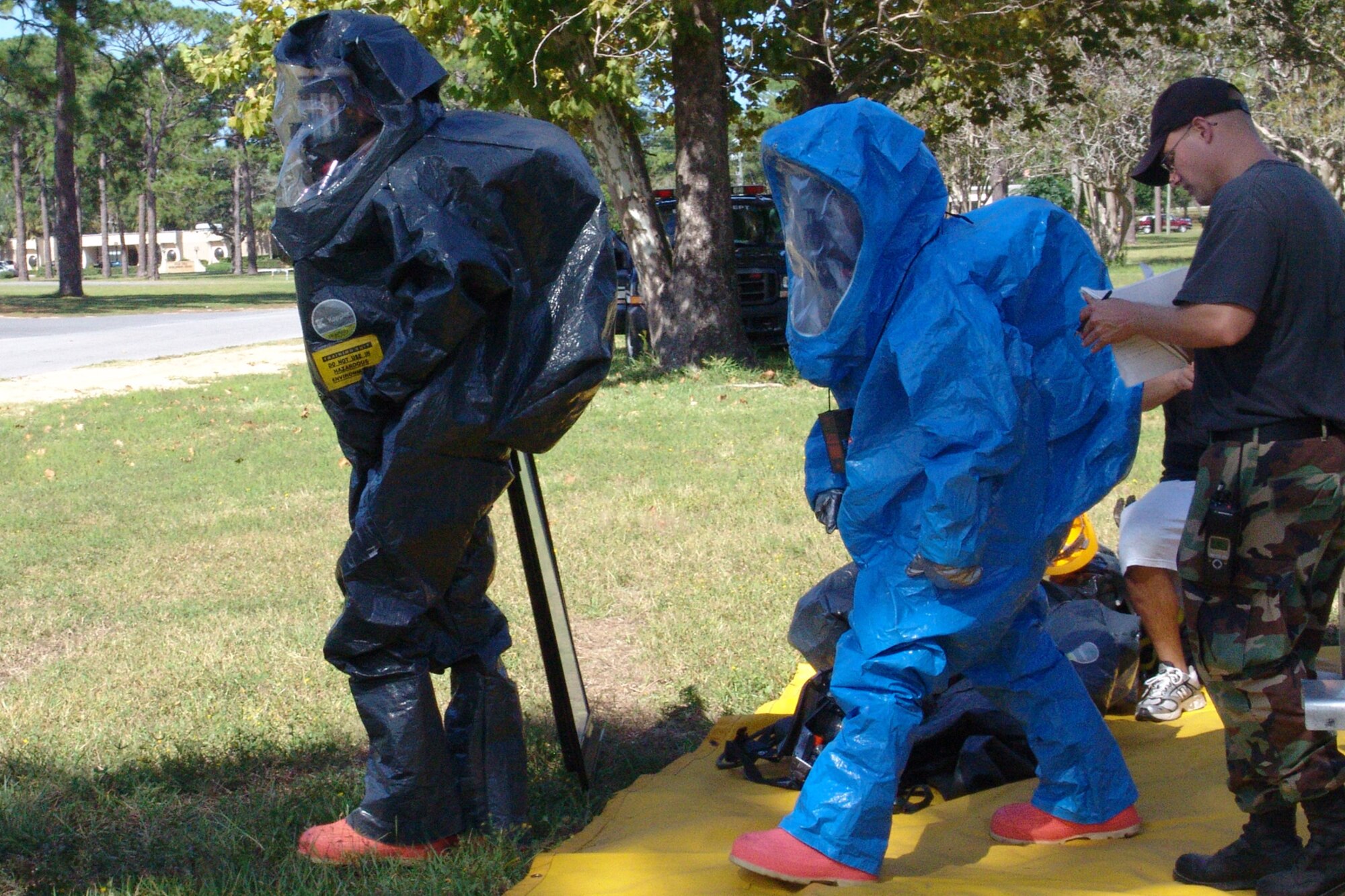 Firefighters with the 96th Civil Engineer Squadron suit up during a hazardous material exercise. They were participants in a hazardous material training session taught by instructors with the Department of Defense's Fire Academy at Goodfellow AFB, Texas. (USAF photo by Lois Walsh)