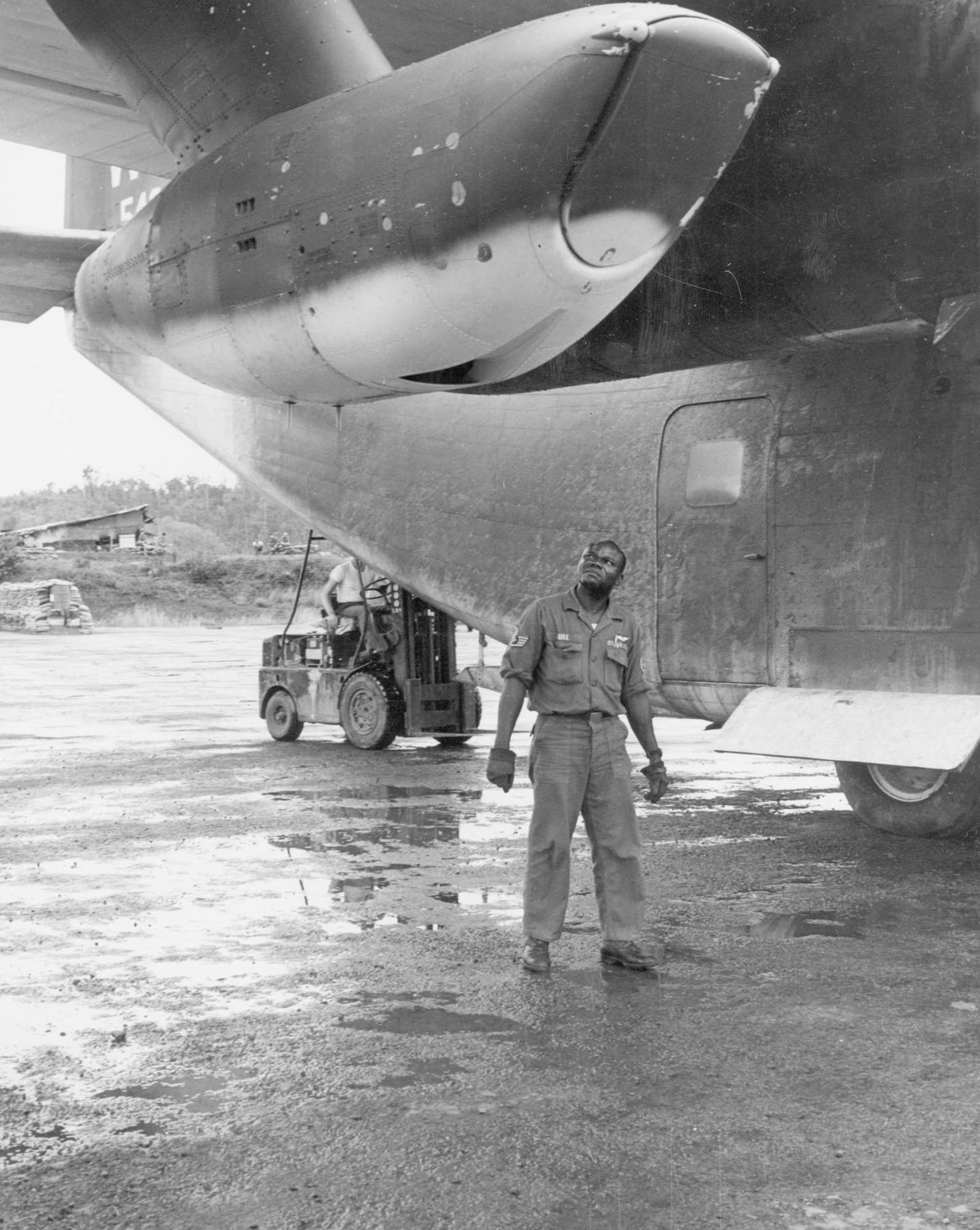 Flight engineer SSgt. Leonard Gill, Jr. examines the J85 engine on a C-123K at Kham Duc, South Vietnam, in 1967. (U.S. Air Force photo)