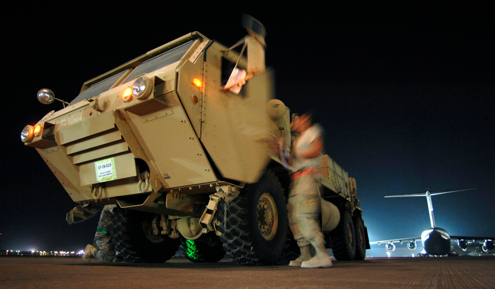 Airmen from the 8th Expeditionary Air Mobility Squadron prepare to load a 58,210 pound armored wrecker onto a C-17 Globemaster Sept. 30 in Southwest Asia. Air mobility in the U.S. Central Command area of operations makes it possible to move people and cargo where needed 24 hours a day, seven days a week. (U.S. Air Force photo/Staff Sgt. Brian Ferguson) 
