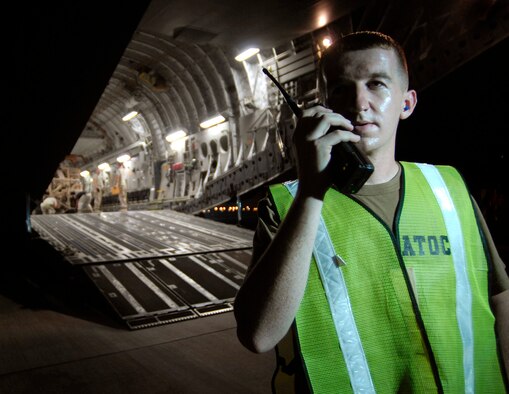 Staff Sgt. Shawn Finch checks in with the Air Terminal Operations Center after helping to load a 58,210-pound armored wrecker onto a C-17 Globemaster Sept. 30 in Southwest Asi. Air mobility in the U.S. Central Command area of operations makes it possible to move people and cargo where needed 24 hours a day, seven days a week. Sergeant Finch is an air terminal operations controller with the 8th Expeditionary Air Mobility Squadron. (U.S. Air Force photo/Staff Sgt. Brian Ferguson)