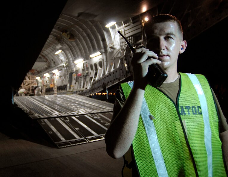 Staff Sgt. Shawn Finch checks in with the Air Terminal Operations Center after helping to load a 58,210-pound armored wrecker onto a C-17 Globemaster Sept. 30 in Southwest Asi. Air mobility in the U.S. Central Command area of operations makes it possible to move people and cargo where needed 24 hours a day, seven days a week. Sergeant Finch is an air terminal operations controller with the 8th Expeditionary Air Mobility Squadron. (U.S. Air Force photo/Staff Sgt. Brian Ferguson)
