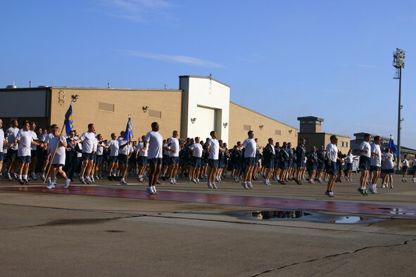 CANNON AIR FORCE BASE, N.M. -- Airmen do jumping jacks before beginning a two-mile commando run on the base flightline Tuesday morning. Airmen from the 27th Special Operations Group and 27th Special Operations Maintenance Group participated in the run. (U.S. Air Force photo by Airman Elliott Sprehe)