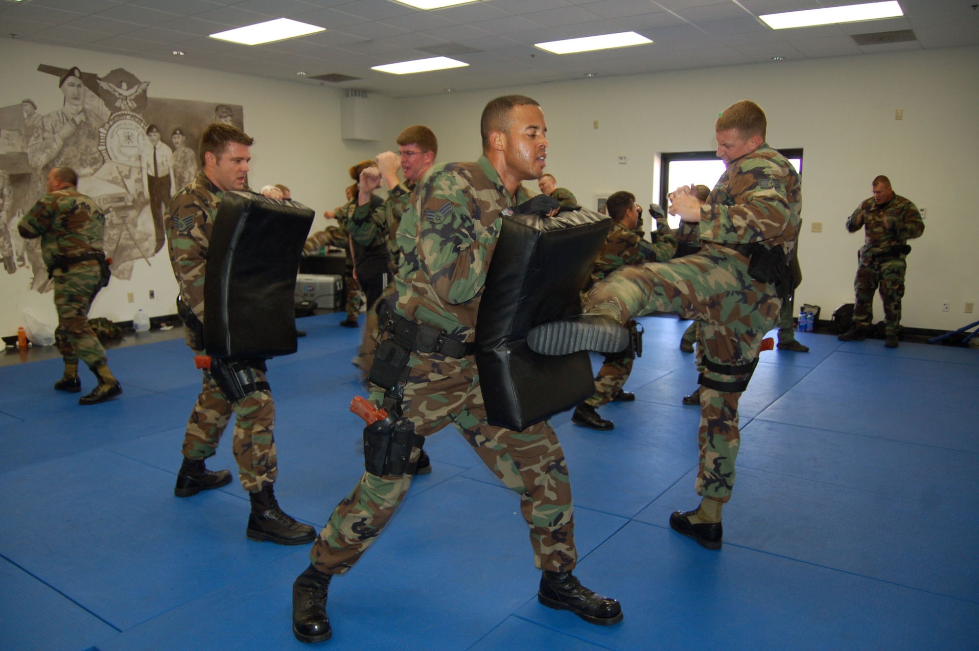 Members of the 95th Security Forces Squadron perform combat techniques during Krav Maga martial arts training here Sept. 14. Krav Maga is the Israeli military's official system of self defense and hand-to-hand combat. (Photo by Senior Airman Julius Delos Reyes)