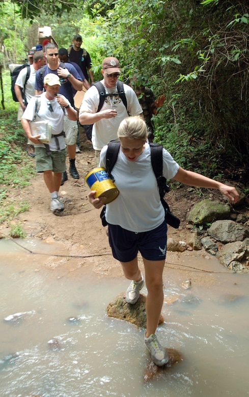 Staff Sgt. Melinda Atencio leads a group of military members across a stream during a hike to deliver food Sept. 29 to a village in the mountains near Comayagua, Honduras. The hike was sponsored by the Joint Task Force-Bravo Chapel from Soto Cano Air Base, and consisted of 55 volunteers who delivered approximately 450 pounds of supplies. (U.S. Air Force photo/Staff Sgt. Austin May)