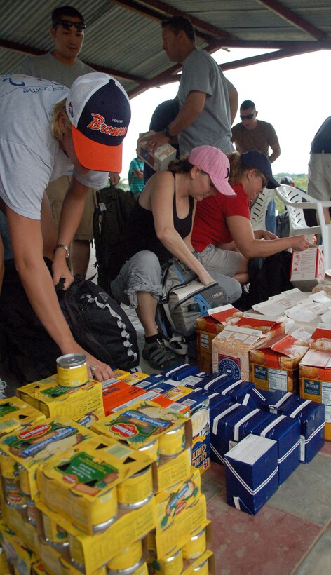 Volunteers pack backpacks full of food for a nearly five-mile hike Sept. 29 into the mountains near Comayagua. The trip, organized by the Joint Task Force-Bravo Chapel from Soto Cano Air Base, Honduras, was to deliver the supplies to families living in the mountains. (U.S. Air Force photo/Staff Sgt. Austin May) 