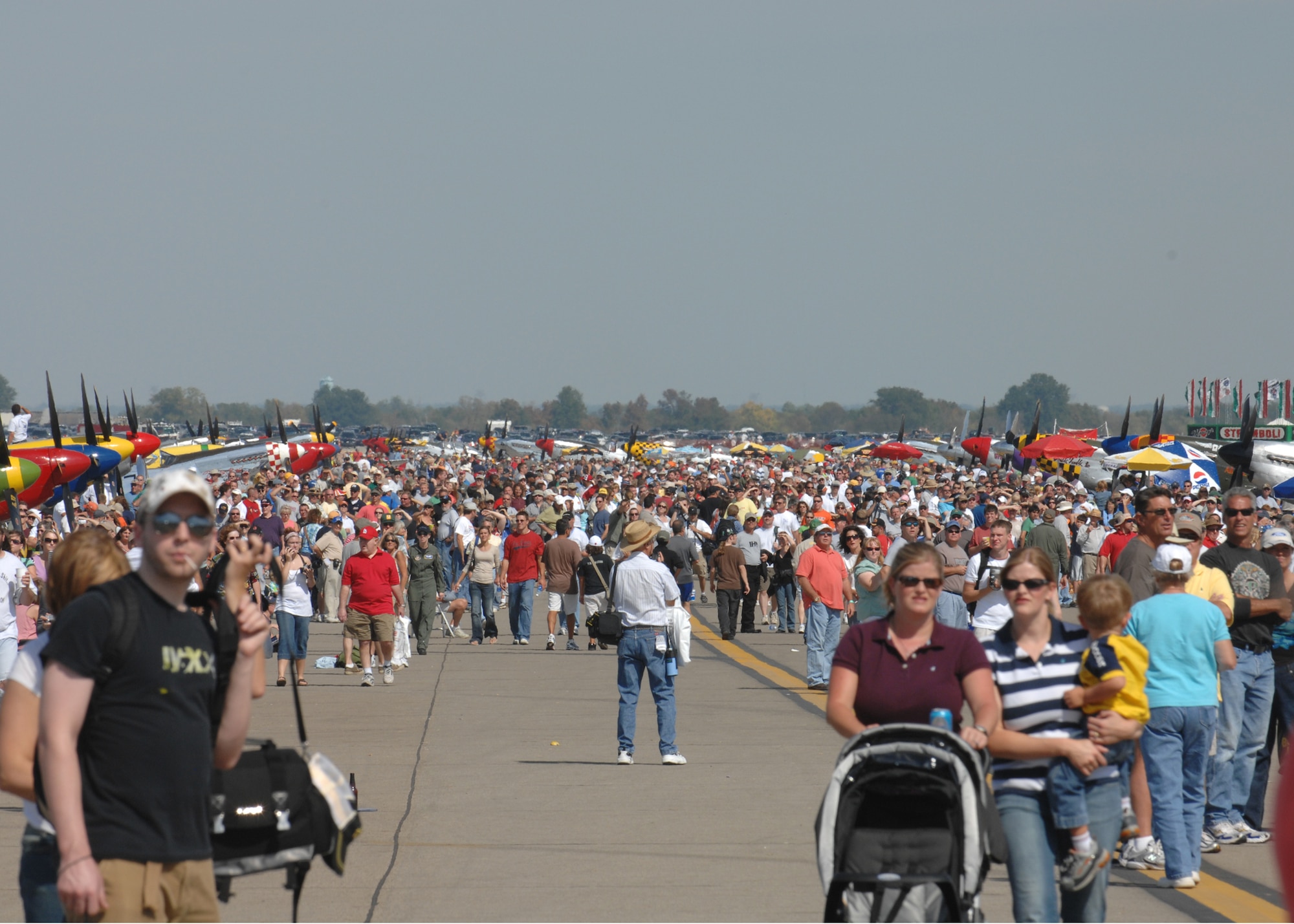 The runway is crowded as spectators walk along the line of P-51s. (Air Force photo by Senior Airman Amanda Cain)
