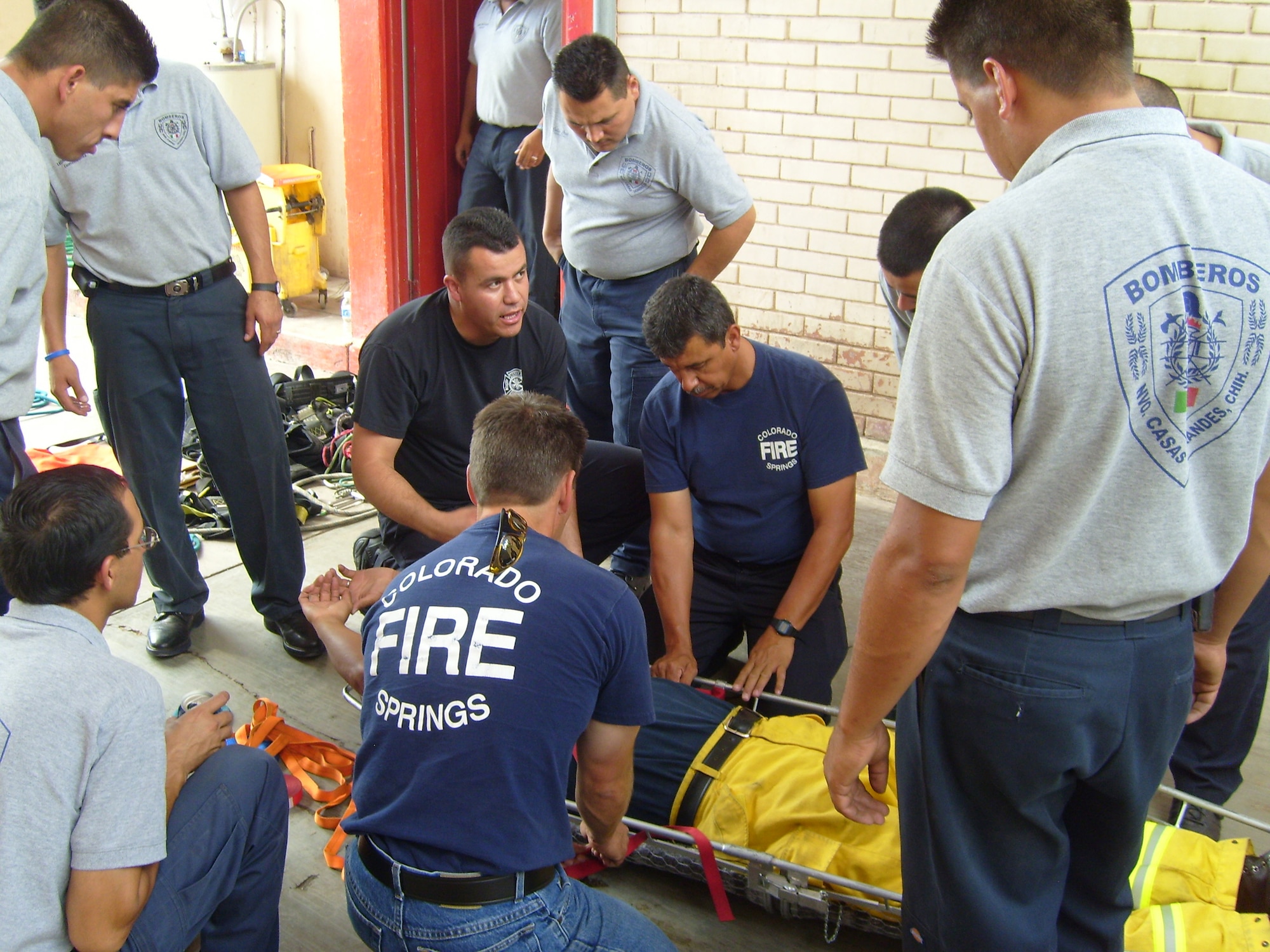 Tech. Sgt. Mario Gonzalez (dark blue shirt, speaking), a member of Peterson’s Fire Department, helps train firefighters in Nuevo Casas Grandes, Mexico. Sergeant Gonzalez joined three other Colorado Springs firefighters this September on a trip to Nuevo Casas Grandes, Colorado Springs’ sister city, to help train the city’s small fire department. (Courtesy photo)
