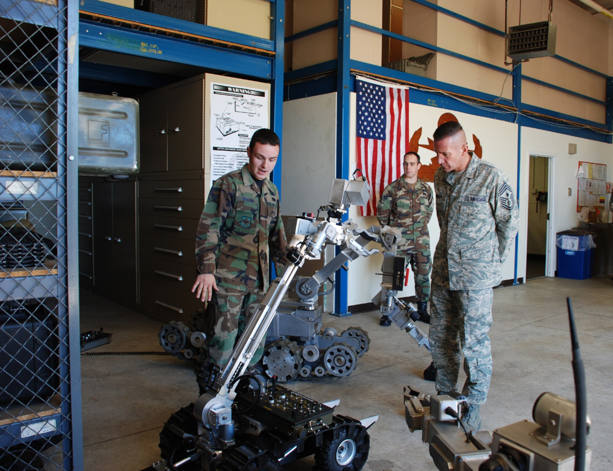 Airman 1st Class Kyle Saplding, 305th Civil Engineer Squadron Explosive Ordnance Disposal technician, demonstrates one of the squadron’s robots to Air Mibility Command’s Command Chief Master Sgt. Joe Barron Sept. 17. The “save a tech, send a robot” device enables EOD teams to get visual data on an item while keeping the technician at a safe distance.  The robots can also carry explosives to an item to detonate it. (U.S. Air Force photo/Staff Sgt. Kelly White)



