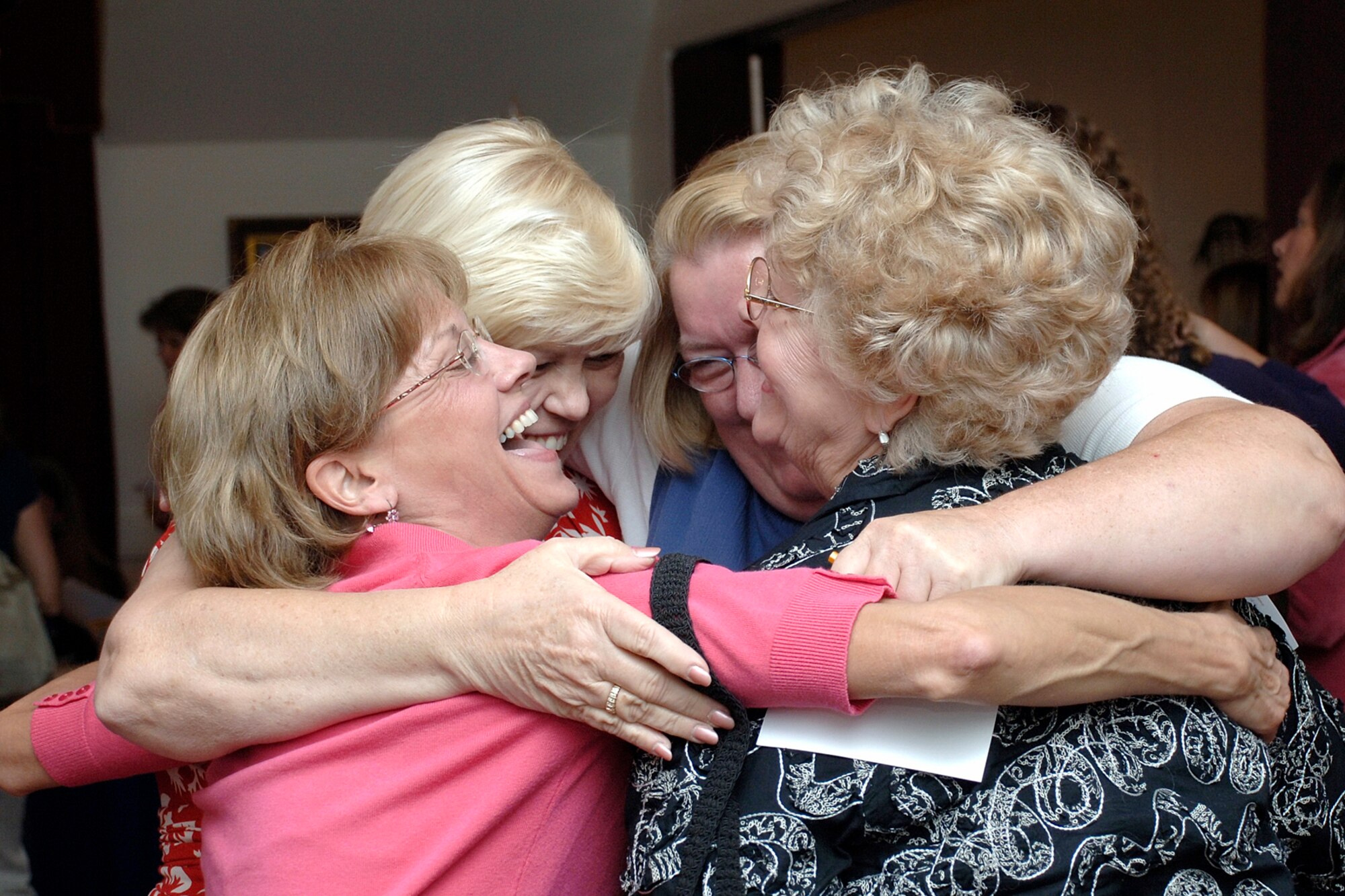 From left, Grace Ann Wade, Carol Burns, Julie Braschler and Rita Prochask, all members of the Hanscom Spouses’ Club, embrace during the club’s recent kick-off event Sept. 25. The theme of the event was, “Common Ground: Together, we’re better.” Members of the Hanscom Spouses’ Club, formerly known as the Hanscom Officers’ Spouses’ Club, voted in May to include more Hanscom spouses in their membership. The club is now open to spouses of all military members, to include the Guard and Reserves, regardless of service or rank. (U.S. Air Force photo by Jan Abate.)