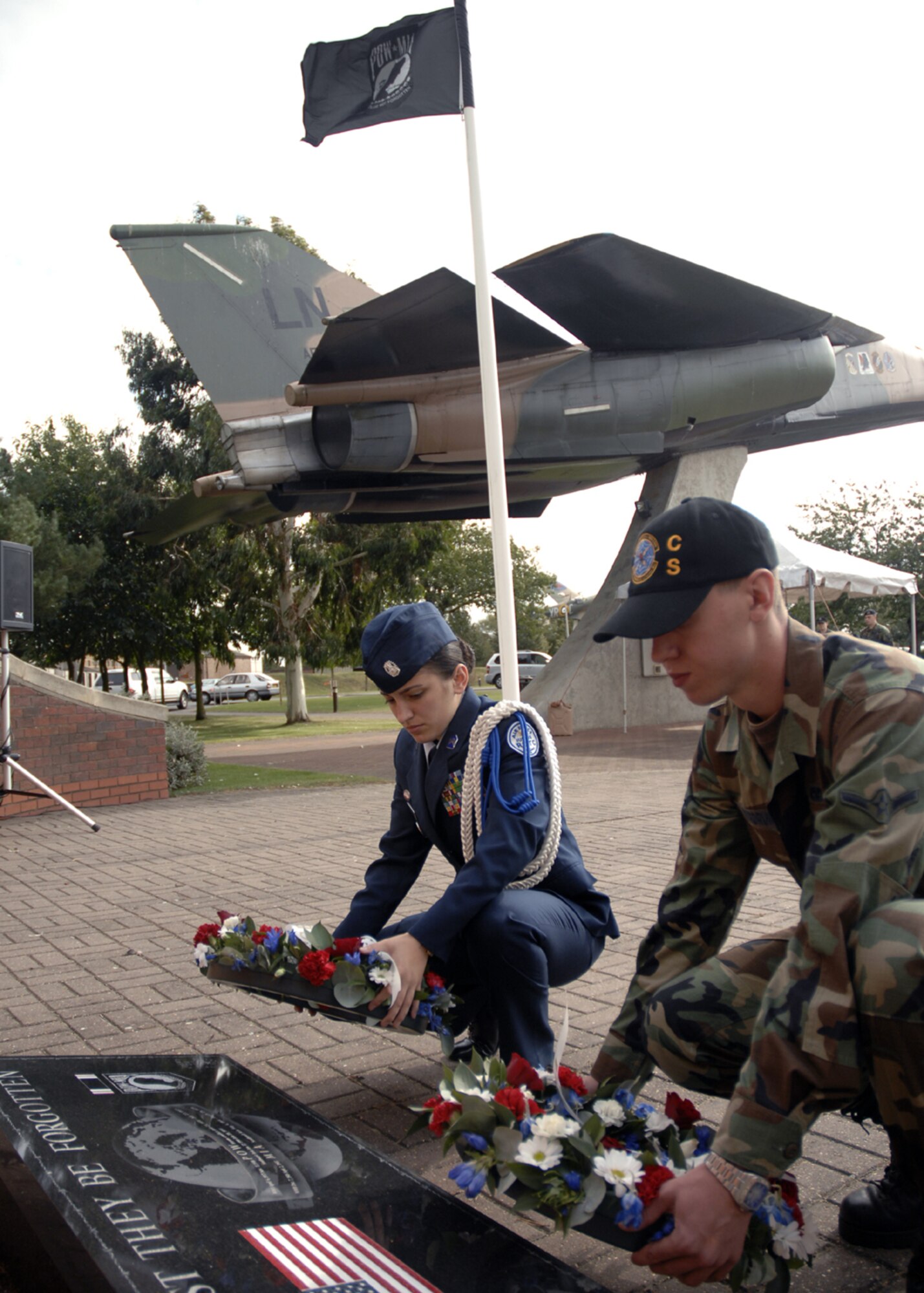 Airman Chad Nordrum, 48th Communications Squadron, and Tia Downey, Lakenheath High School JROTC cadet, lay the POW/MIA wreath in front of the Lest We Forget memorial park Sept. 20 during the POW/MIA remembrance ceremony. (U.S. Air Force photo by Airman 1st Class Erika Brooke)