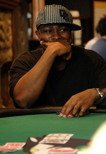 KUNSAN AIR BASE, South Korea - Vanu Garrett, information protection technician 8th Communication Squadron watches his opponent's during a Texas Hold 'Em tournament Sept. 28 here. Garrett, along with other 8th Fighter Wing members, participated in various events during the Wing Sports Day. The sports day allows Airmen a way to compete in friendly and fun competitions, while helping to build esprit de corps. The day kicked off with a wing run and events, ranging from a softball tournament to unit paintball challenges. (U.S. Air Force photo/ TSgt Quinton T. Burris)       