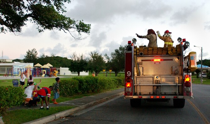 The Kadena Fire Department kicked off fire prevention weeks Oct. 1 with a parade of emergency vehicles. The parade was held to promote safety and fire prevention and was on the anniversary of the Great Chicago fire. McGruff the Crime Dog and Sparky rode around the housing area here, throwing candy to the children.  (U.S. Air Force photo/Tech. Sgt. Reynaldo Ramon)