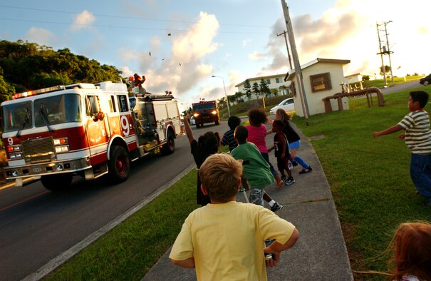 The Kadena Fire Department kicked off fire prevention weeks Oct. 1 with a parade of emergency vehicles. The parade was held to promote safety and fire prevention and was on the anniversary of the Great Chicago fire. McGruff the Crime Dog and Sparky rode around the housing area here, throwing candy to the children.  (U.S. Air Force photo/Tech. Sgt. Reynaldo Ramon)