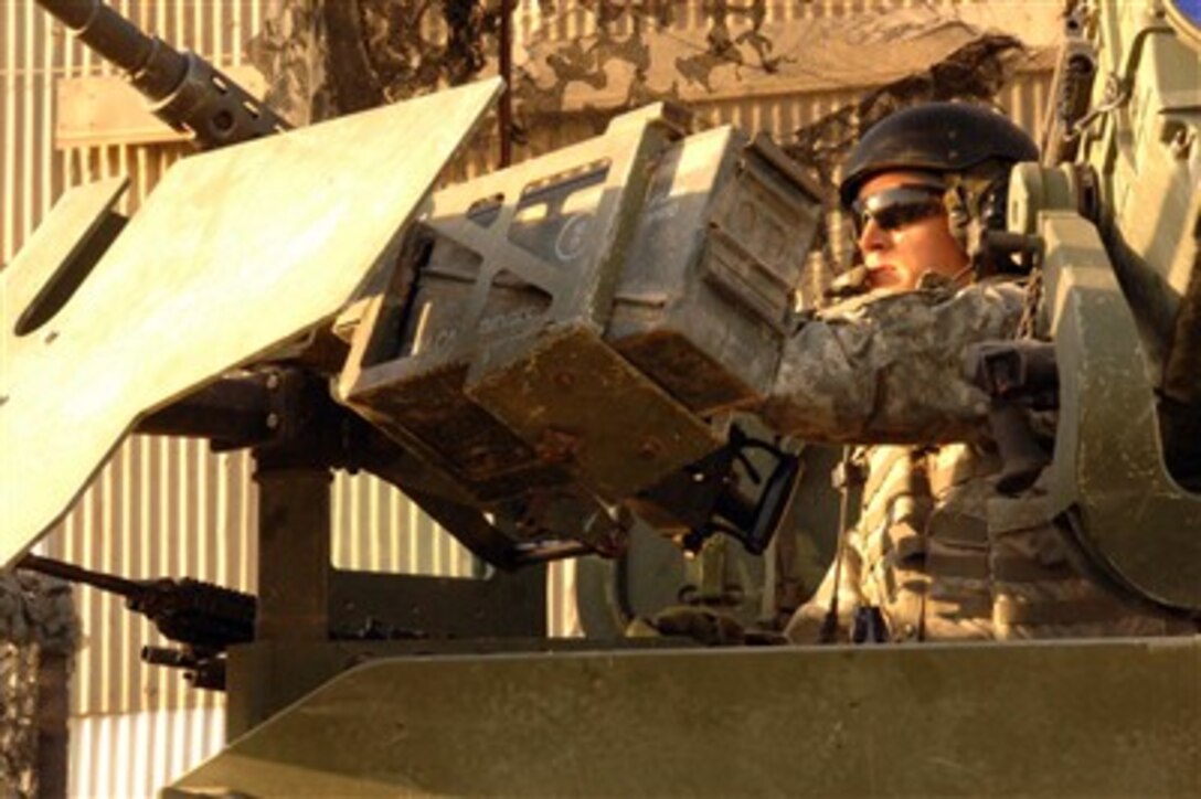 U.S. Army Sgt. Caisy Loop provides security from the gunner's seat of a Stryker combat vehicle during a patrol in Baghdad, Iraq, on Sept. 17, 2007.  Loop is assigned to 4th Squadron, 2nd Stryker Cavalry Regiment, 1st Armored Division.  
